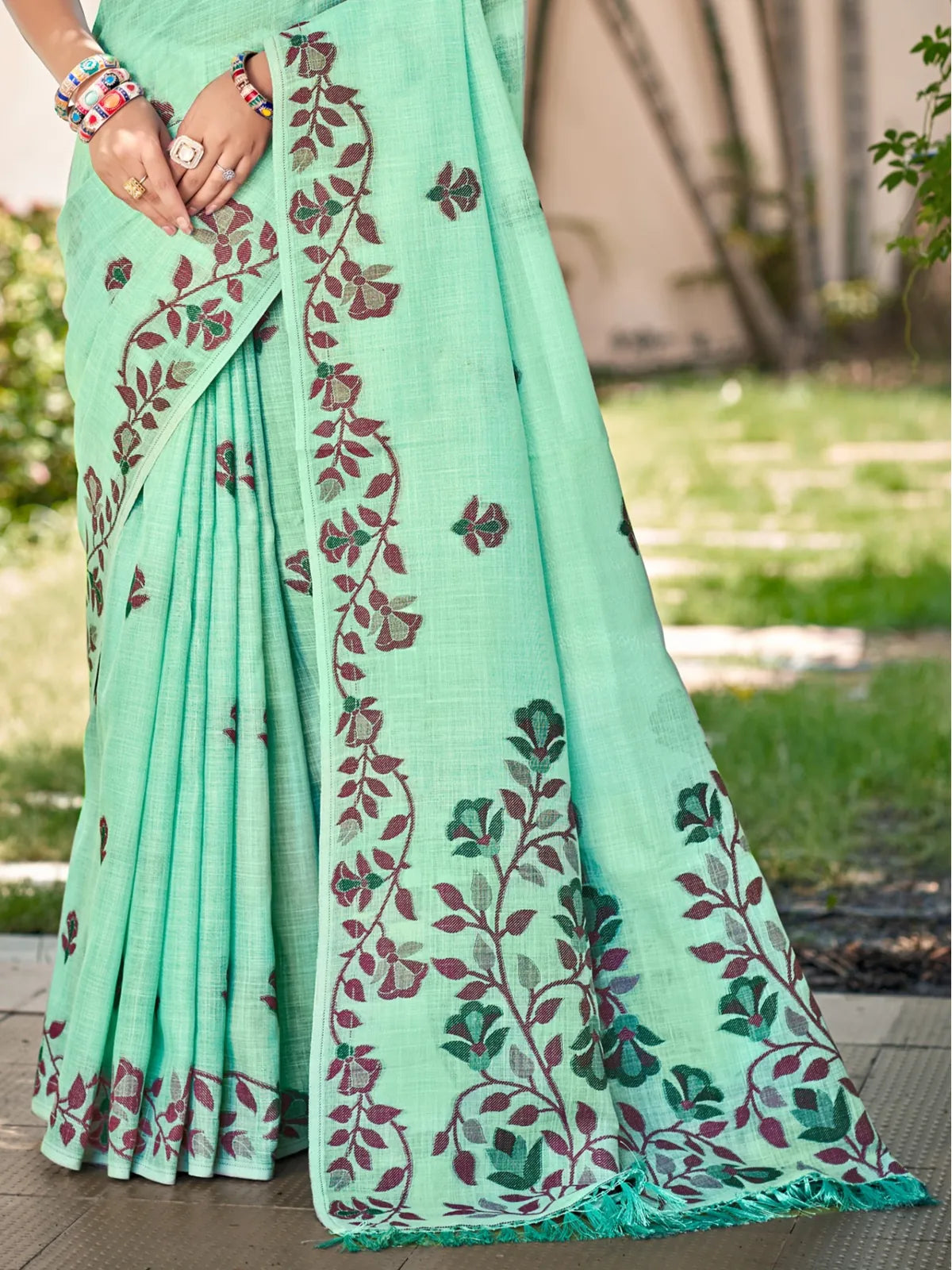 Tarani mint green Lilen saree close-up view highlighting embroidered border and texture