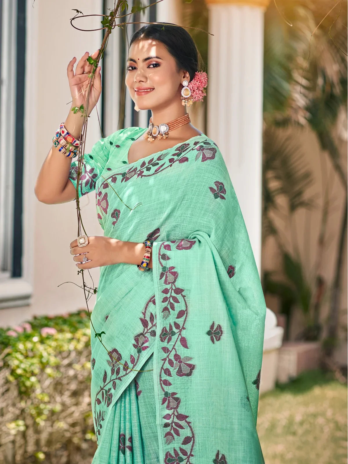 Tarani mint green Lilen saree upper body view showing elegant floral design and jewelry