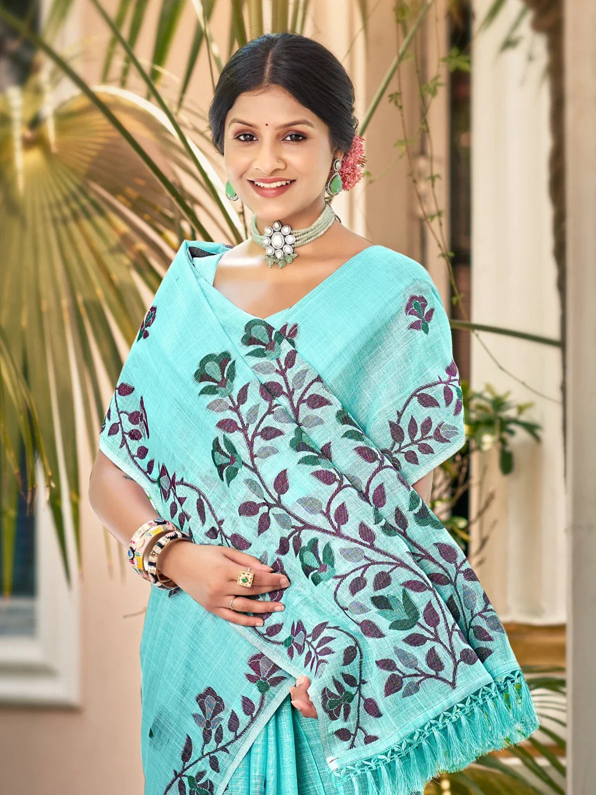 Tarani turquoise lilen saree upper body view with elegant floral motifs
