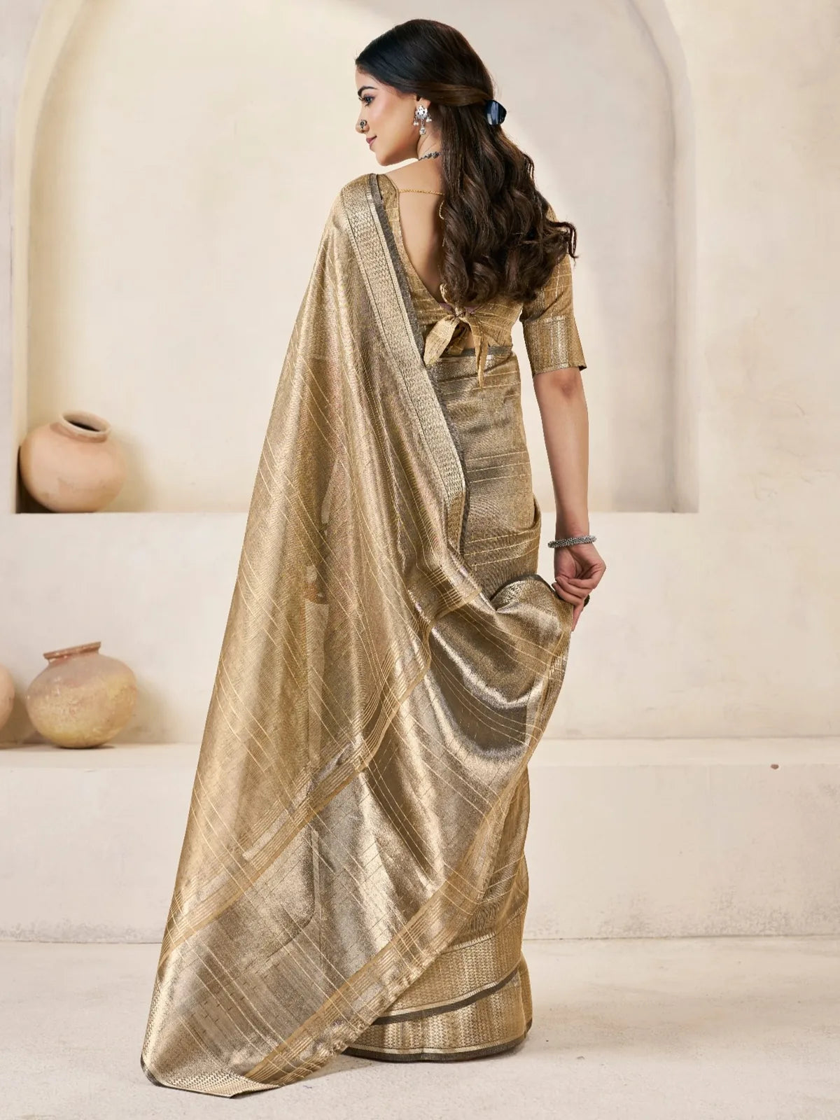 Tarani golden saree back view with blouse design and flowing pallu
