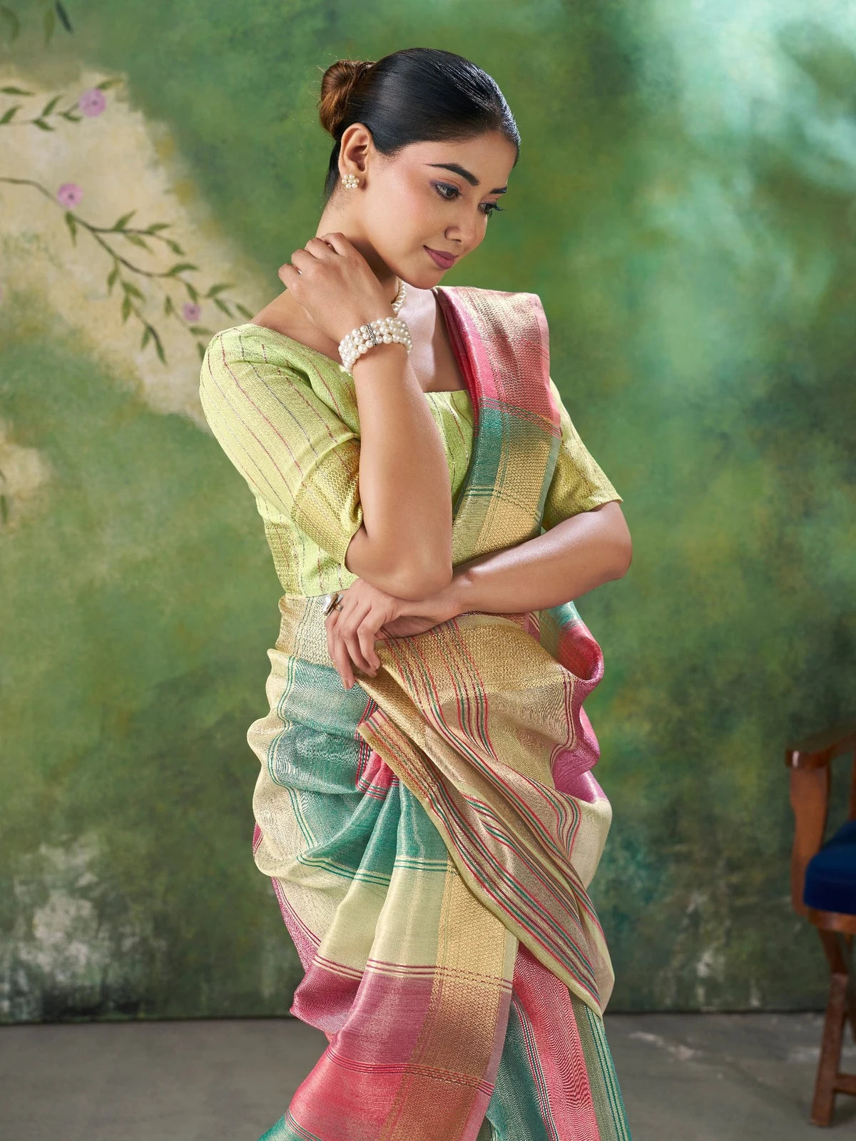 Tarani Falguni green pallu view featuring woven zari border detailing