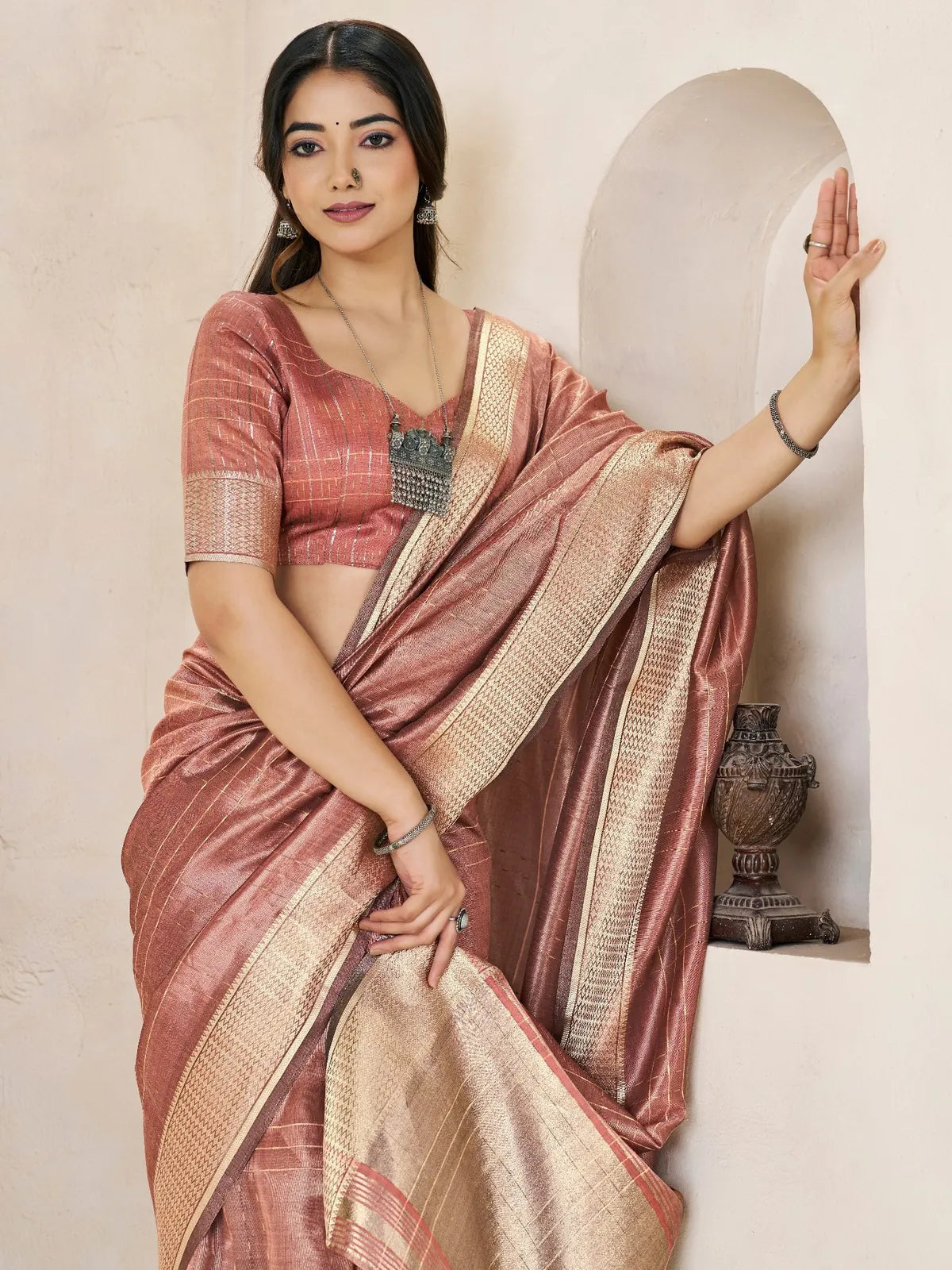 Tarani Amala rose pink saree pallu view showcasing rich zari border detailing