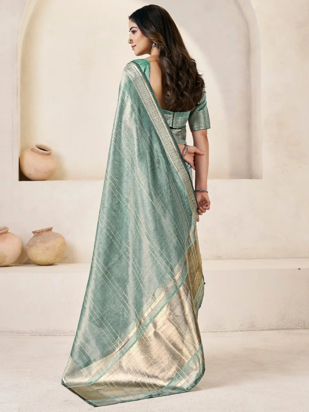 Tarani sea green linen cotton silk saree back view showcasing flowing pallu and zari detailing