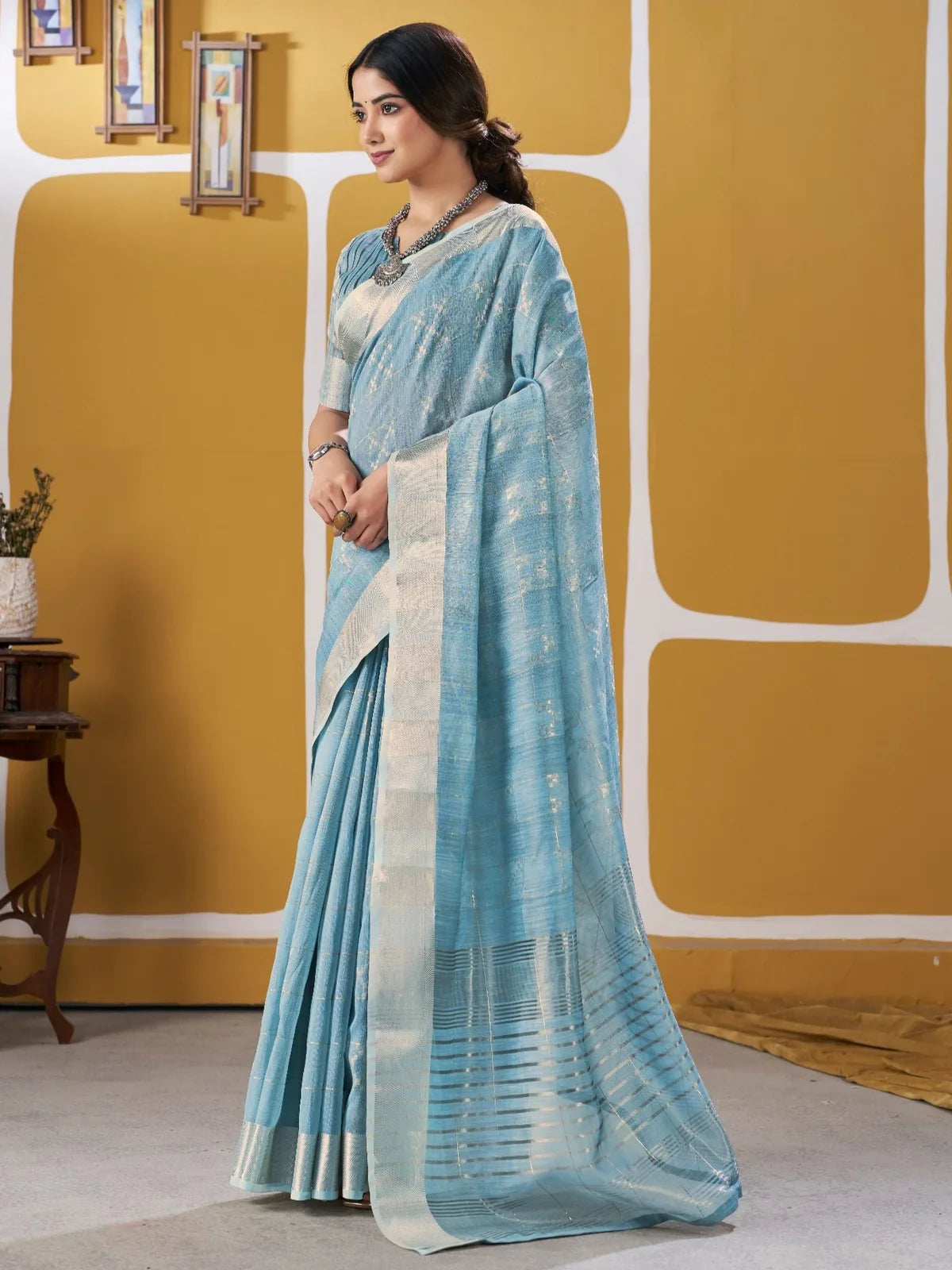 Tarani sky blue zari work saree side view highlighting elegant drape and border design