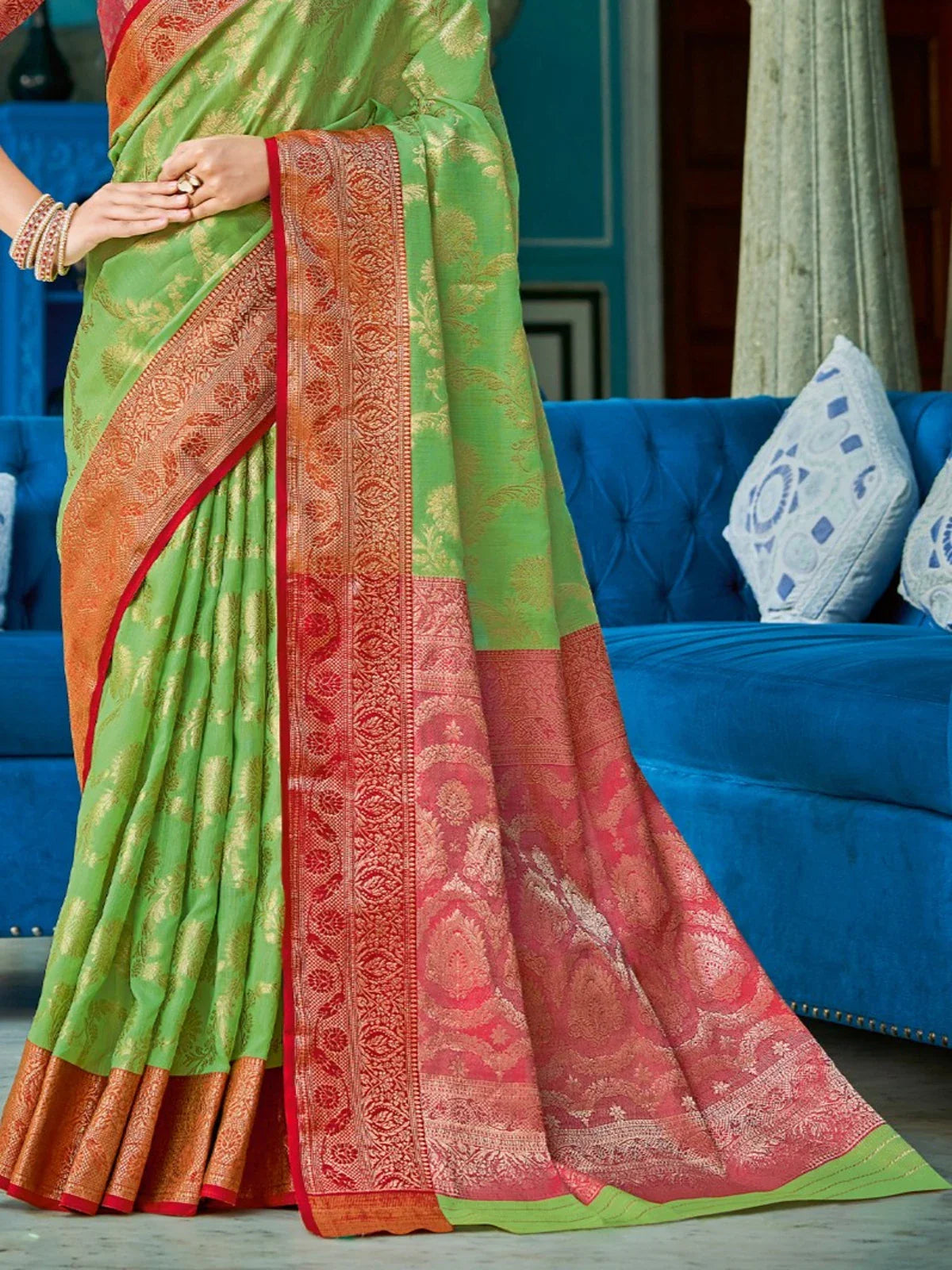 Tarani festive green linen cotton saree pallu view with rich red weaving and golden zari details