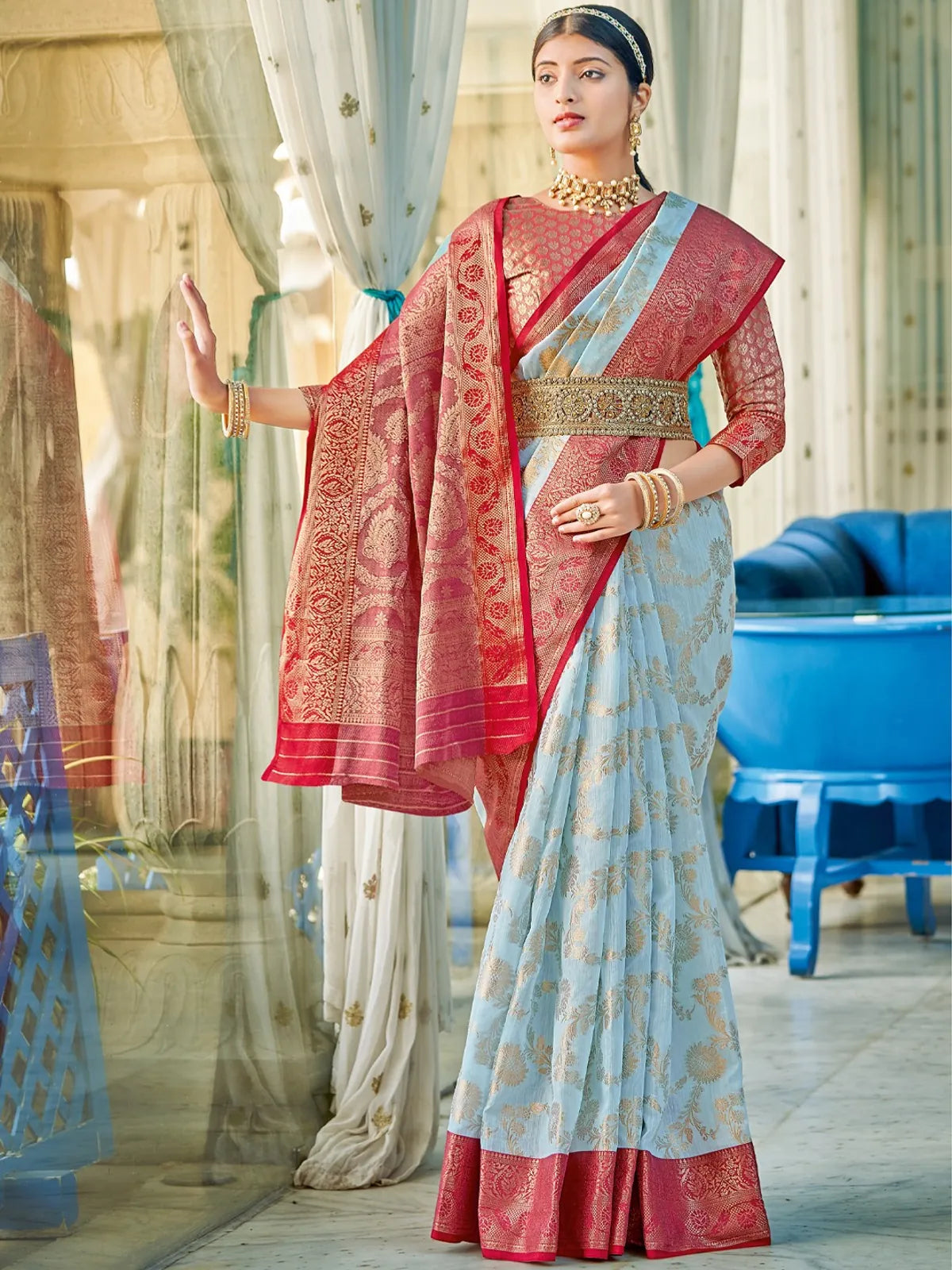 Tarani light blue linen cotton saree full view with red border and festive design