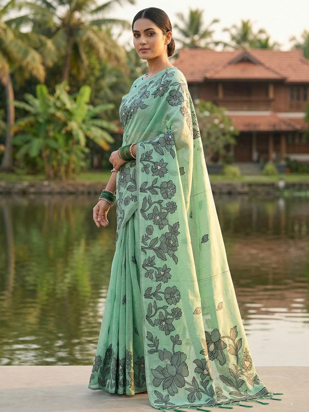 Tarani mint green linen cotton saree side view featuring floral pallu and elegant drape