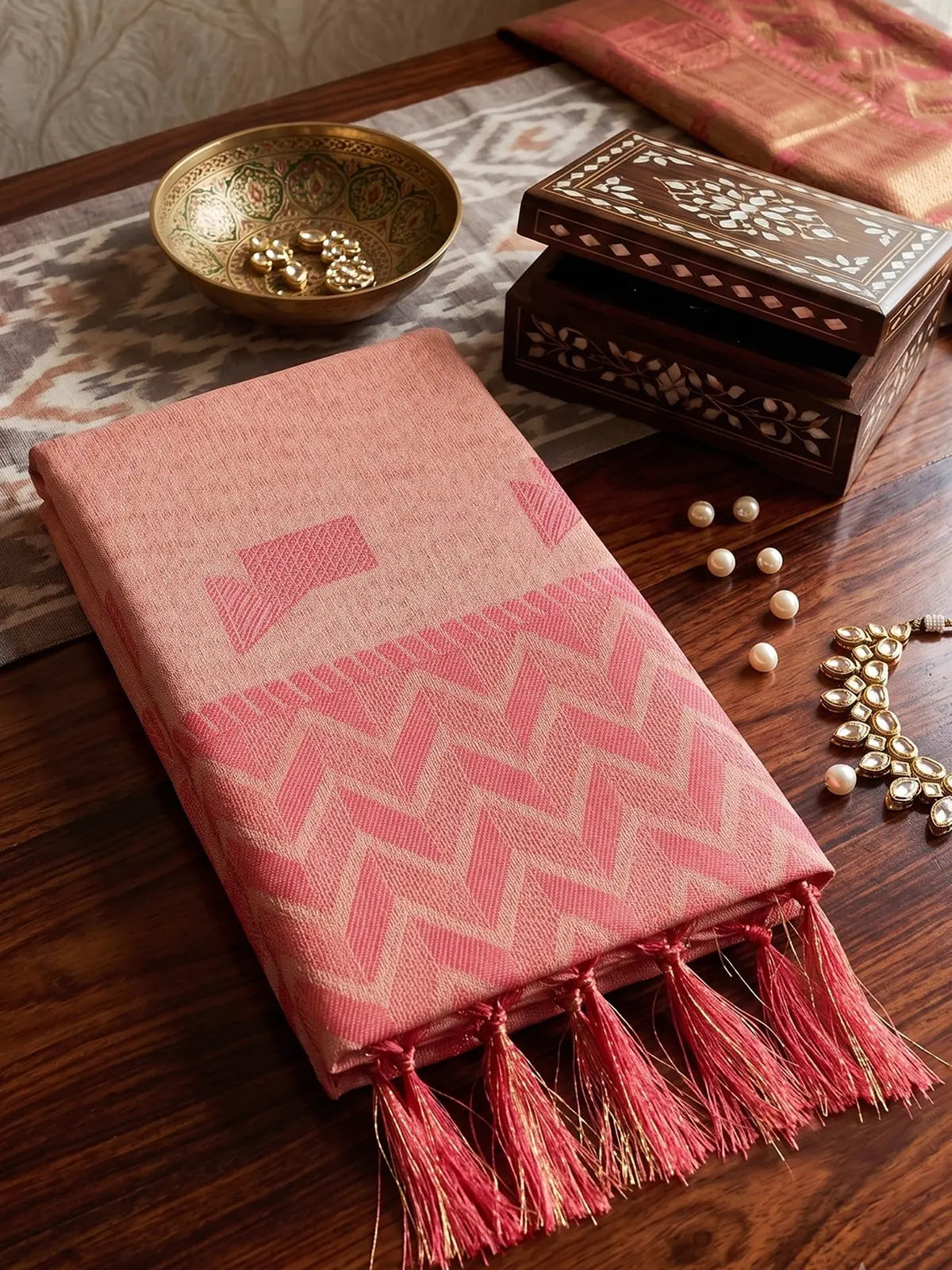Tarani peach linen cotton saree closeup showing woven border and tassels