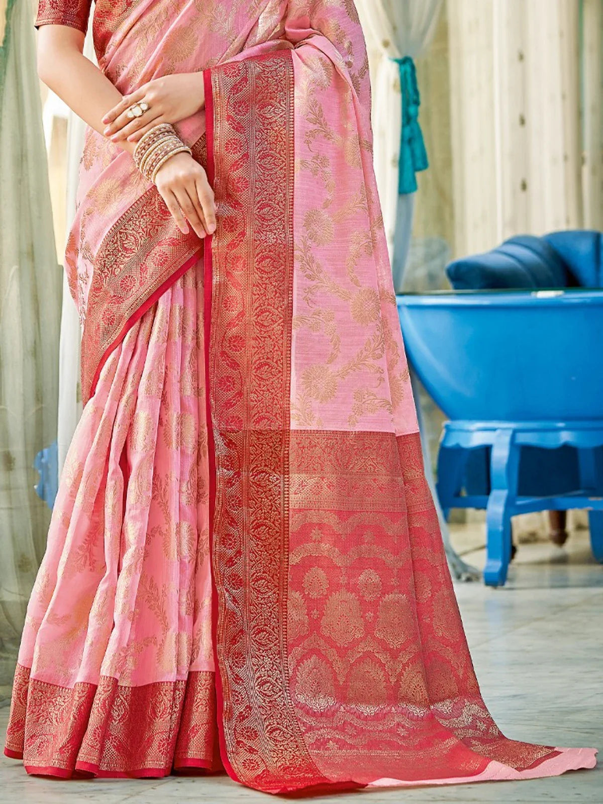 Tarani pink linen cotton saree with detailed pallu and golden zari weaving for festive occasions