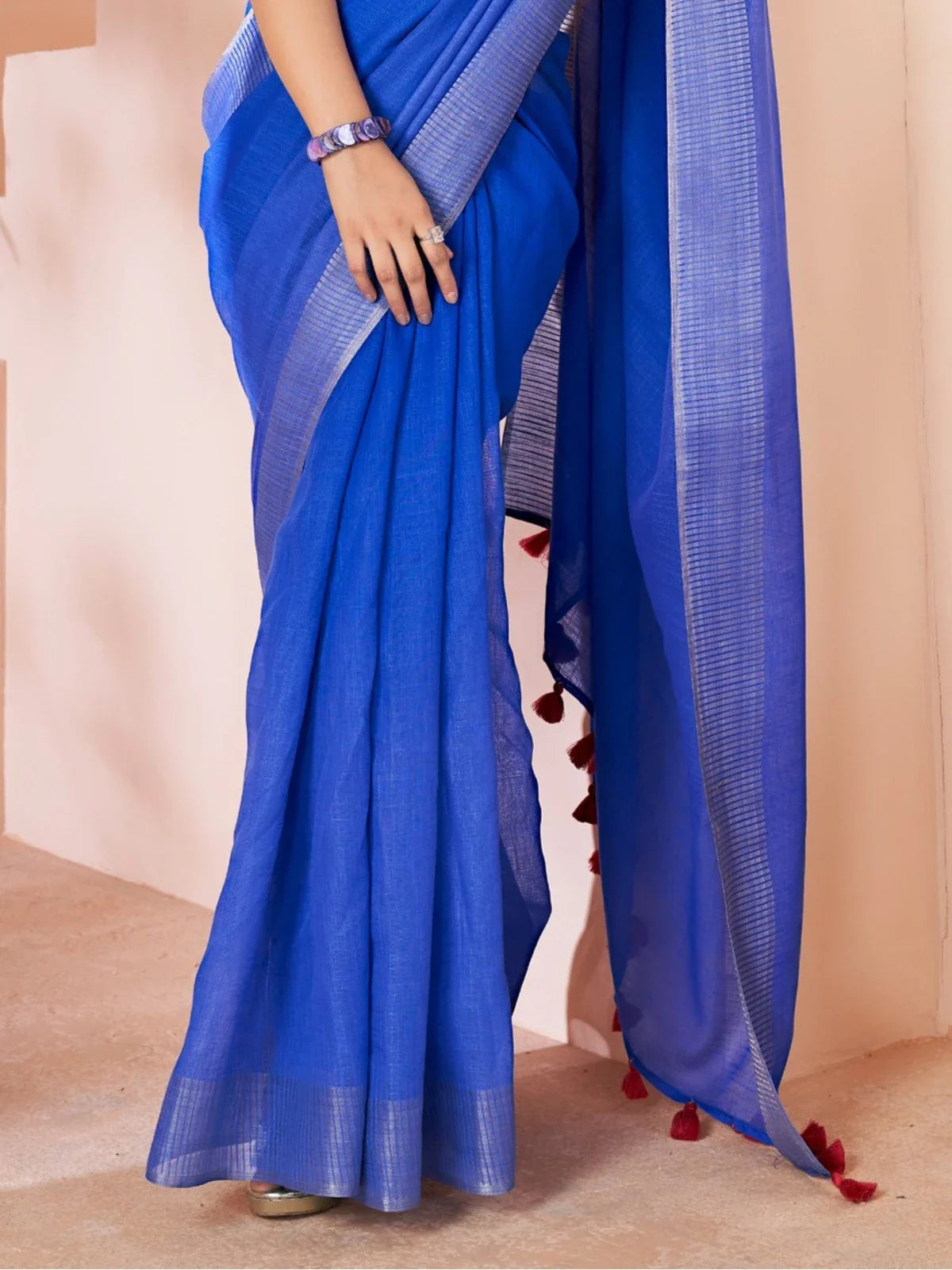 Tarani blue linen saree closeup view highlighting fine weave and red tassel border