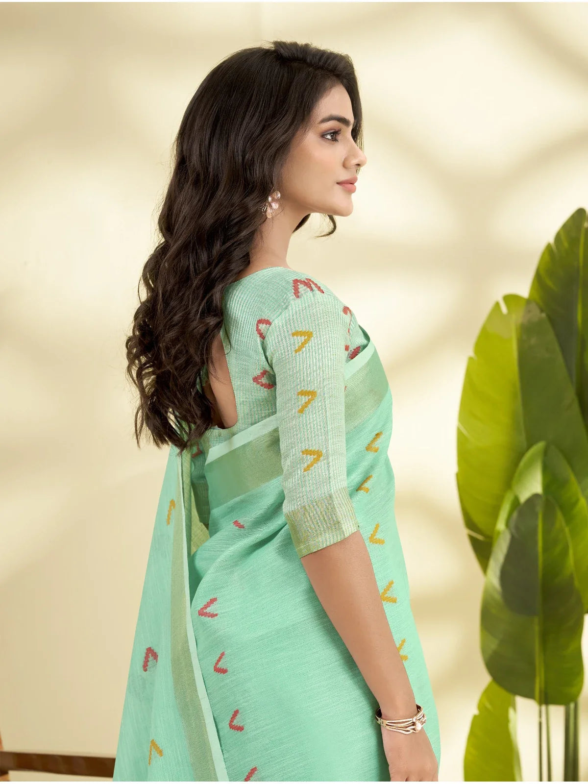 Tarani green linen silk saree with elbow sleeve blouse and side profile view