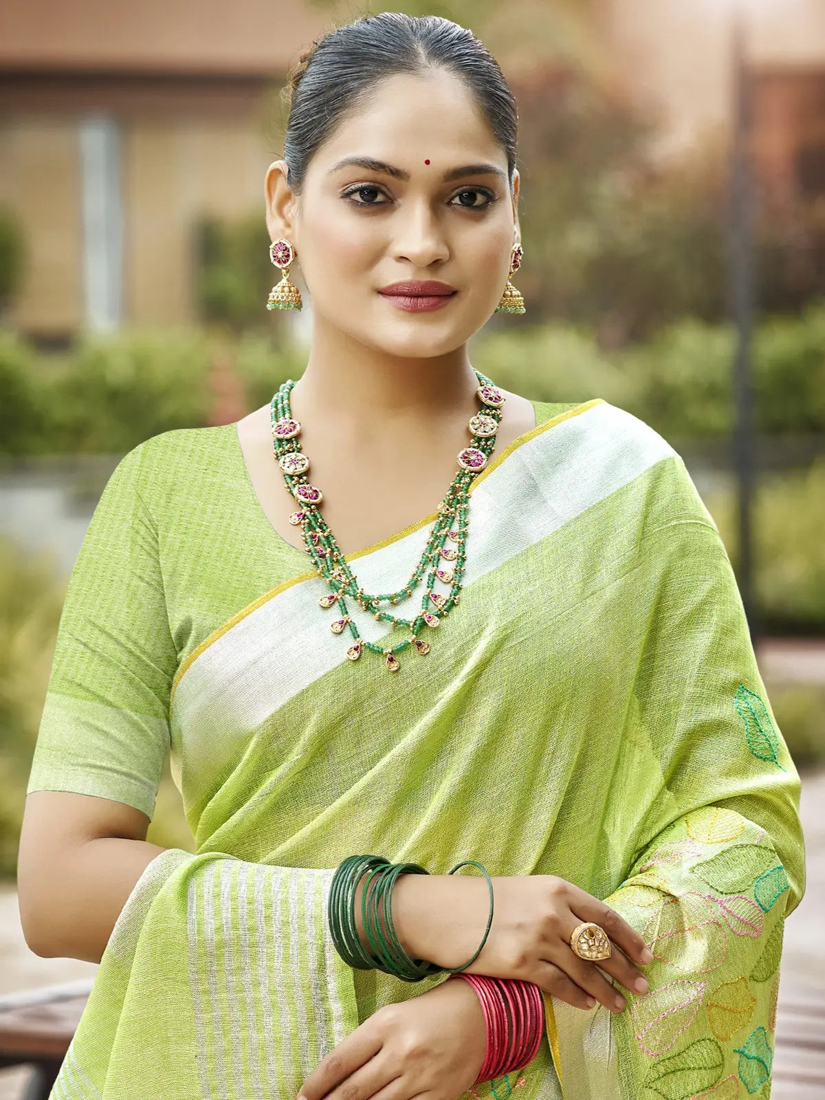 Tarani elegant green linen saree upper body closeup with blouse piece