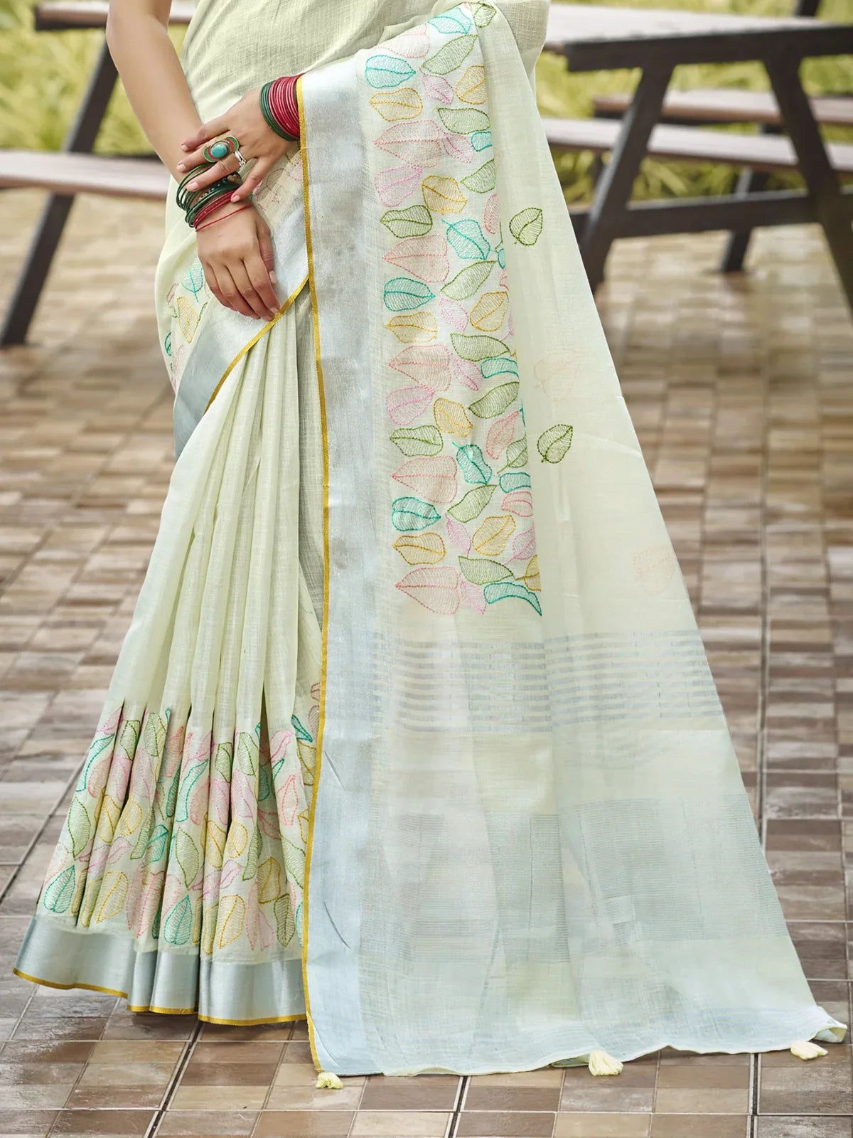 Tarani light green linen saree showcasing pastel embroidered pallu design