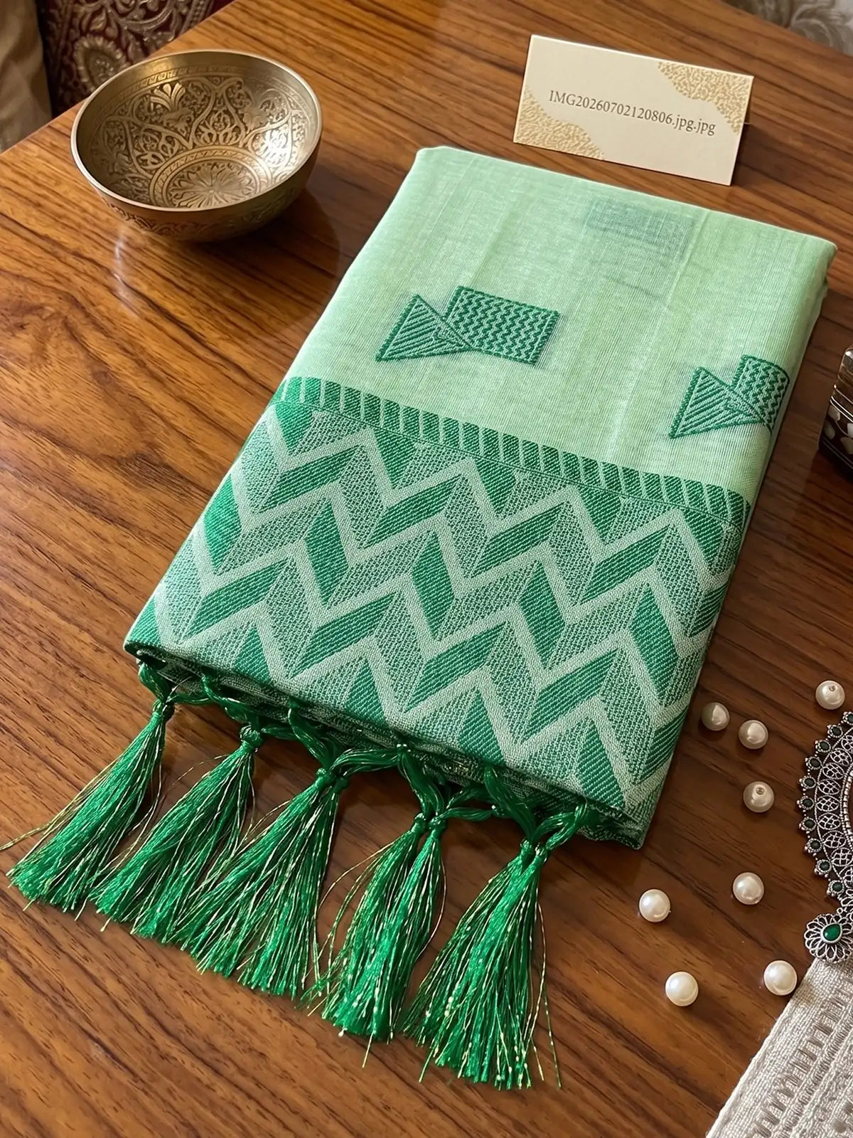 Tarani mint green linen cotton saree closeup of woven pallu and tassels