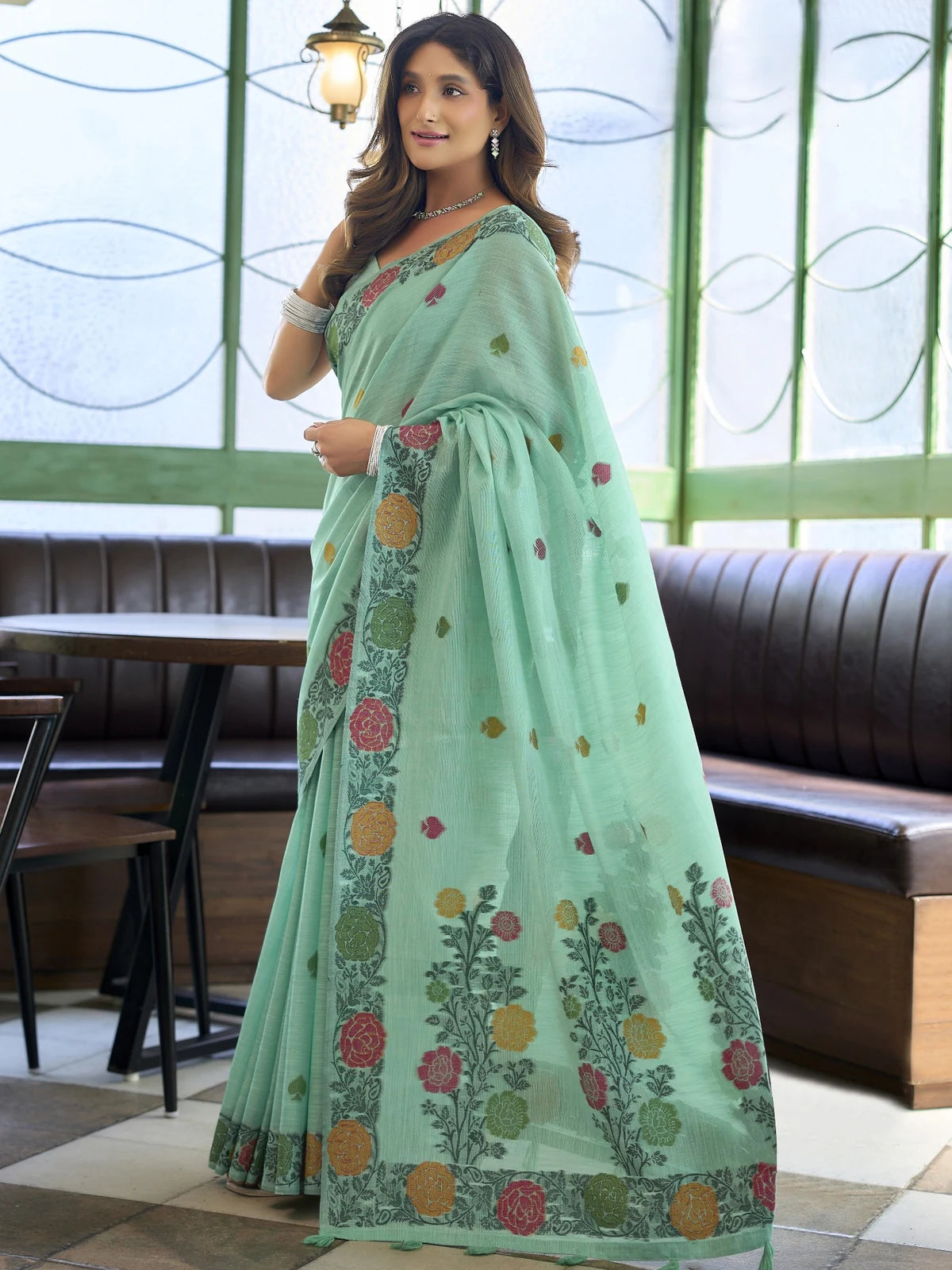 Tarani floral woven mint green linen saree with elegant pallu and tassel detailing
