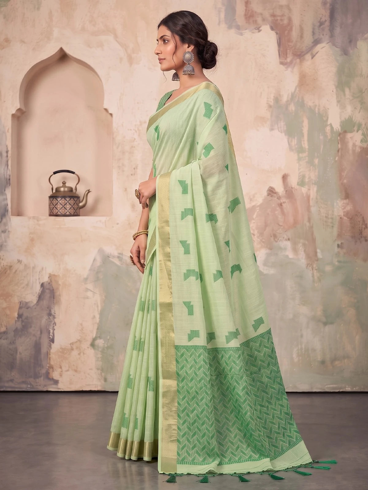 Tarani mint green linen cotton saree elegant side view showing border and drape
