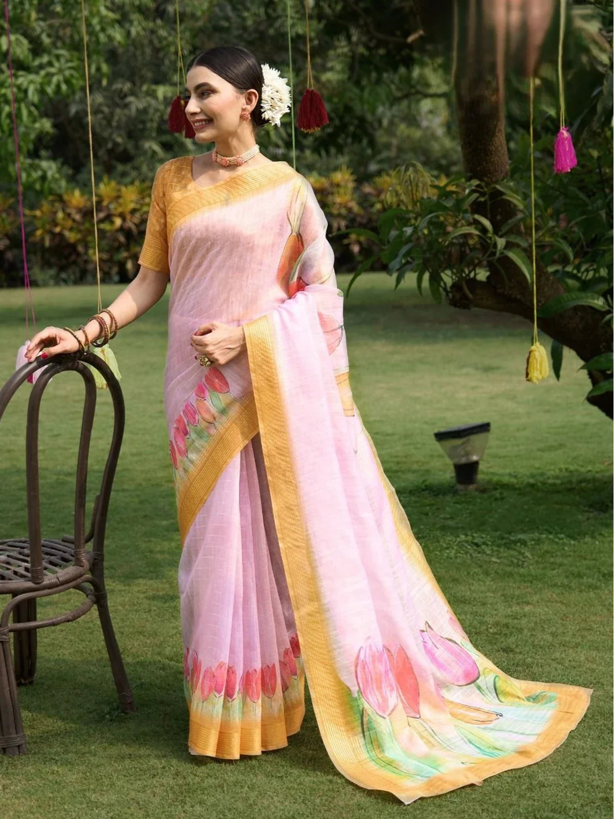 Tarani pink linen saree full view with golden border and floral pallu perfect for parties