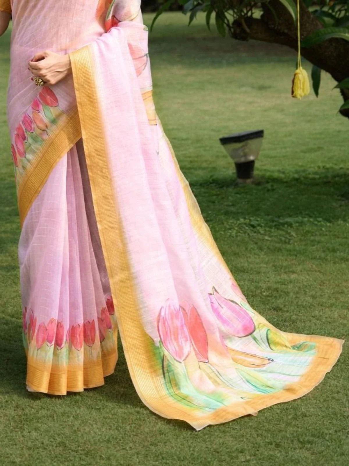 Tarani pink linen saree pallu closeup showing hand painted lotus flowers and border detailing
