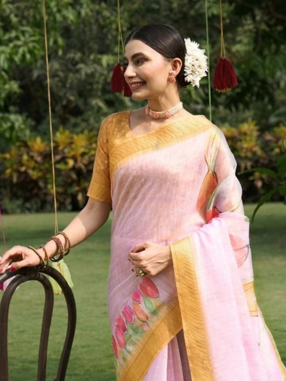 Tarani pink linen saree upper body view showing golden blouse and floral design
