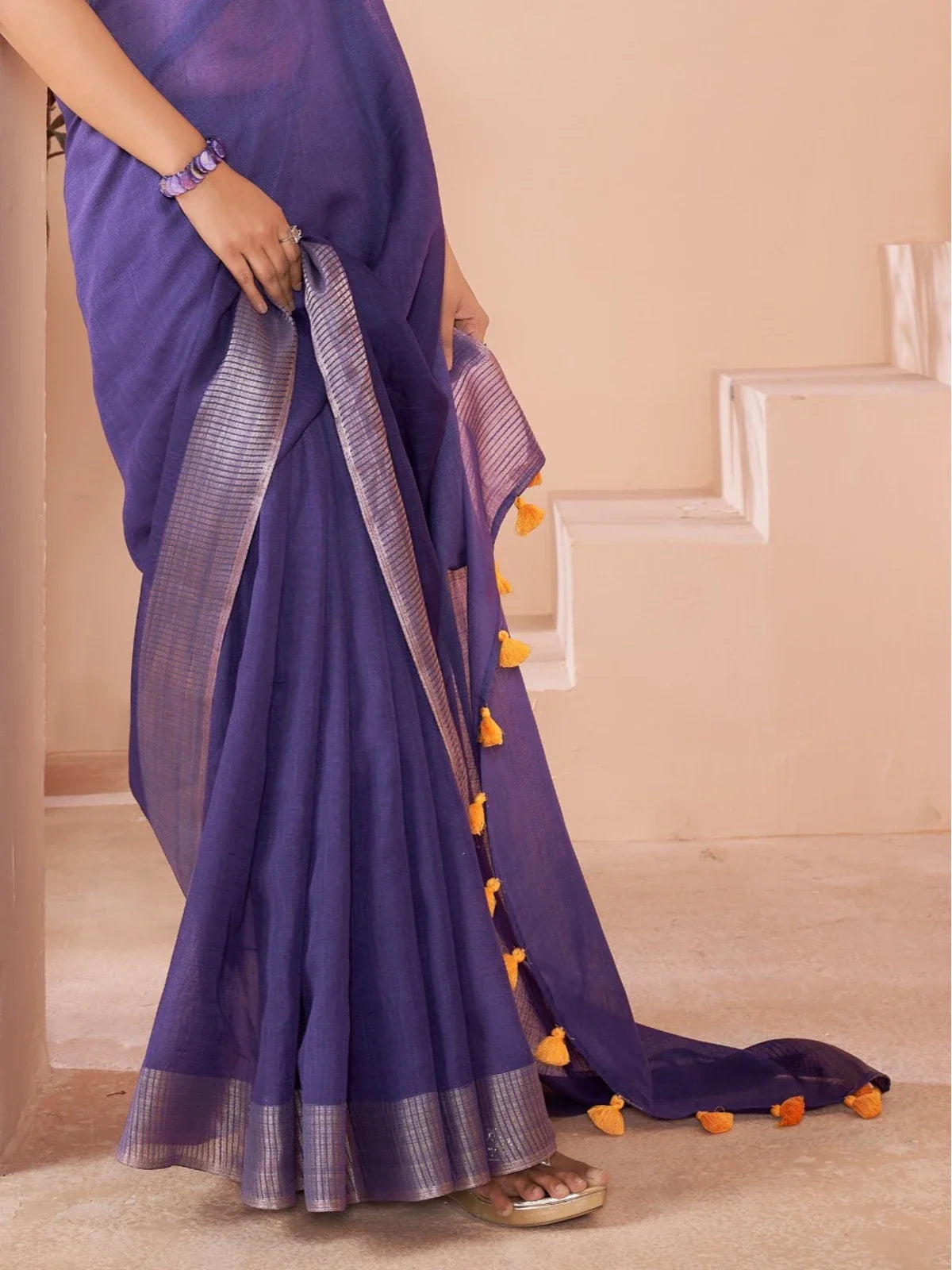 Tarani royal purple linen saree with yellow tassel detailing on pallu close view