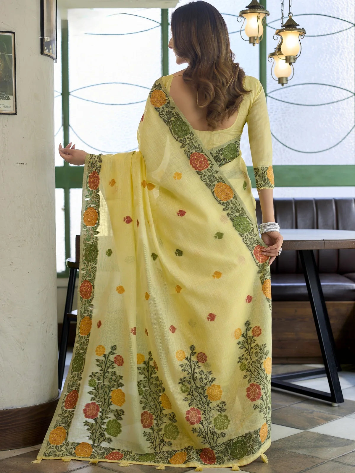 Tarani yellow linen jacquard saree back view with woven floral pallu and tassel detailing