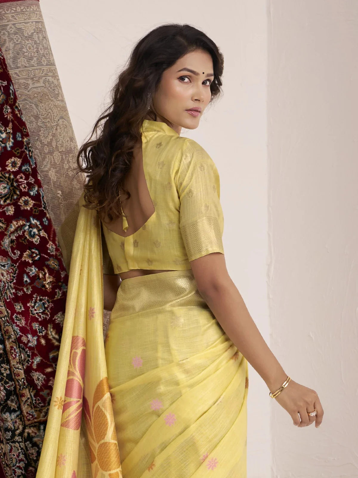 Tarani linen saree blouse back view with stylish open-back design and soft yellow tone
