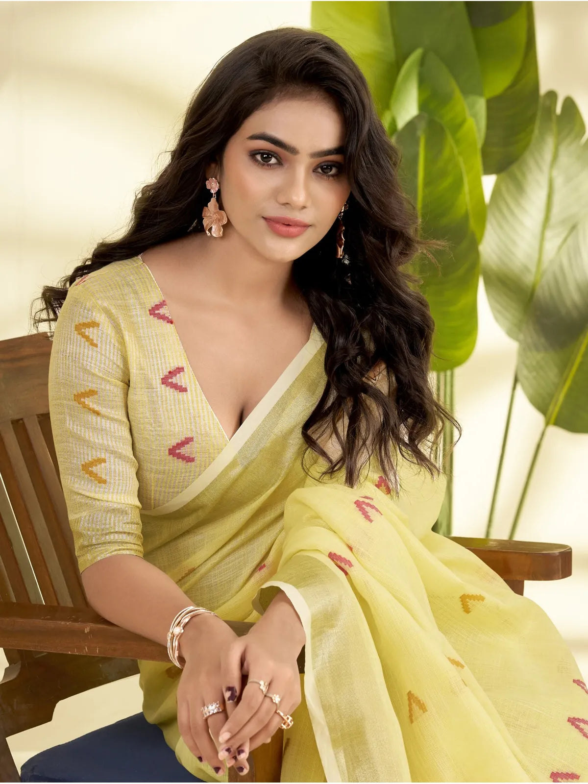 Tarani closeup view of yellow linen silk saree with multicolor motifs and zari detailing