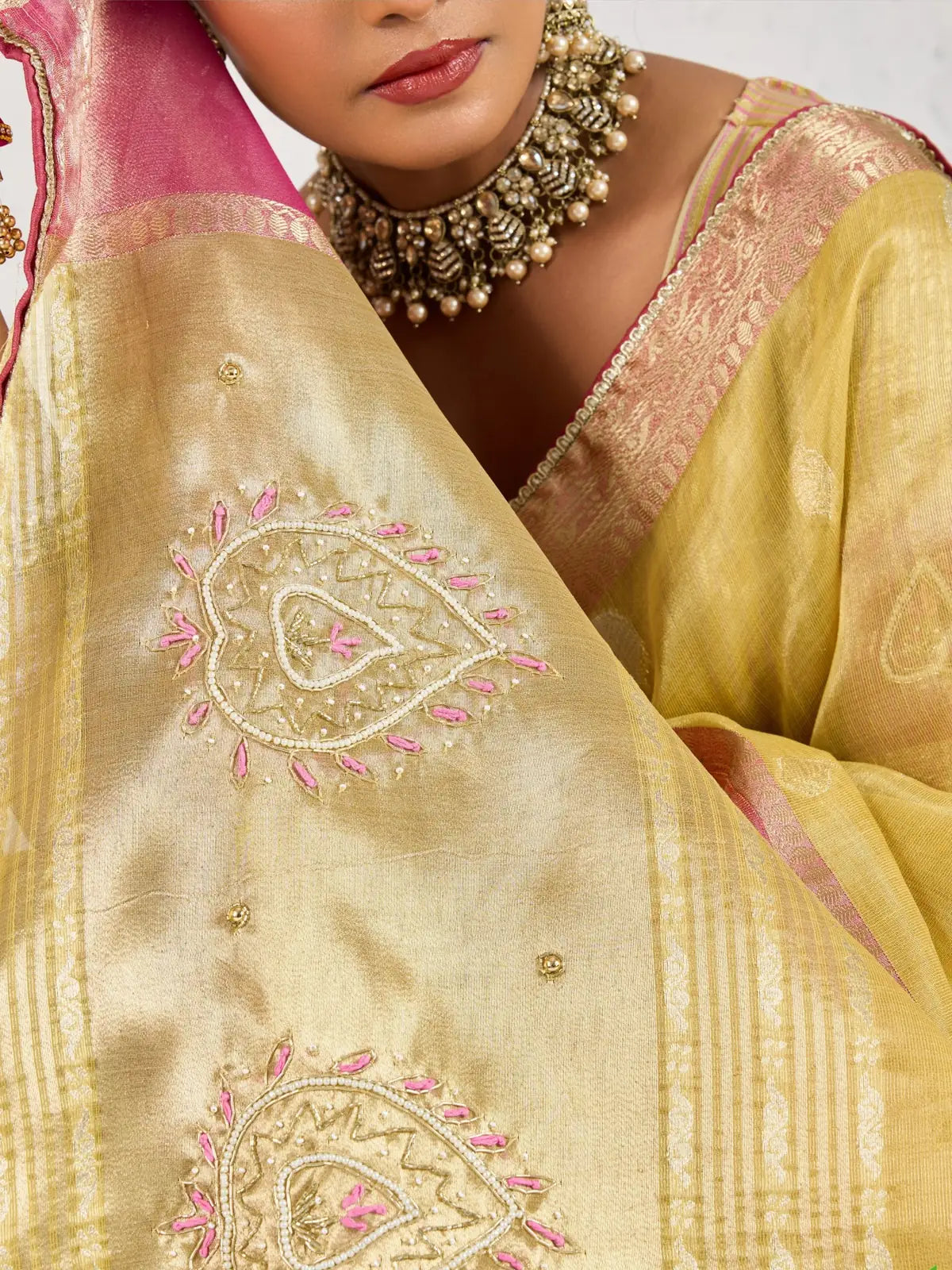 Tarani yellow linen saree closeup showing zari butta and handwork detail