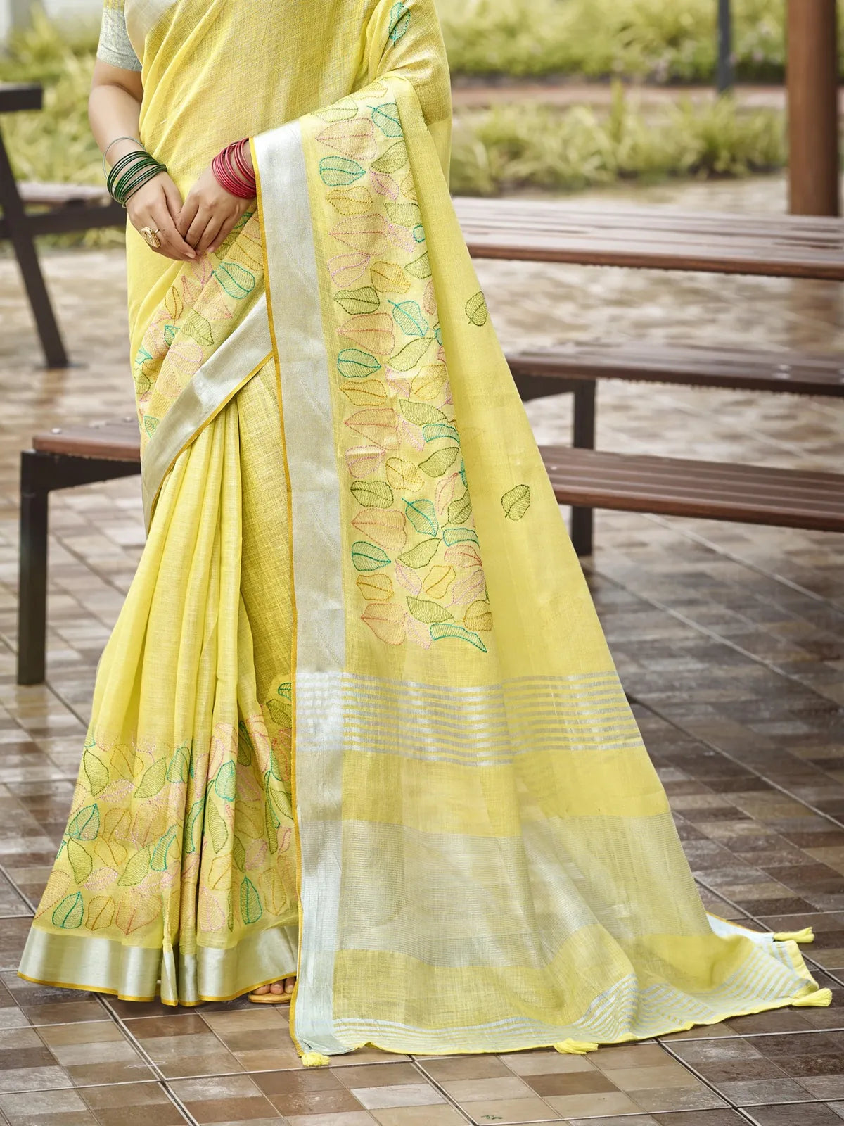 Tarani yellow linen saree pallu close view with embroidered leaves