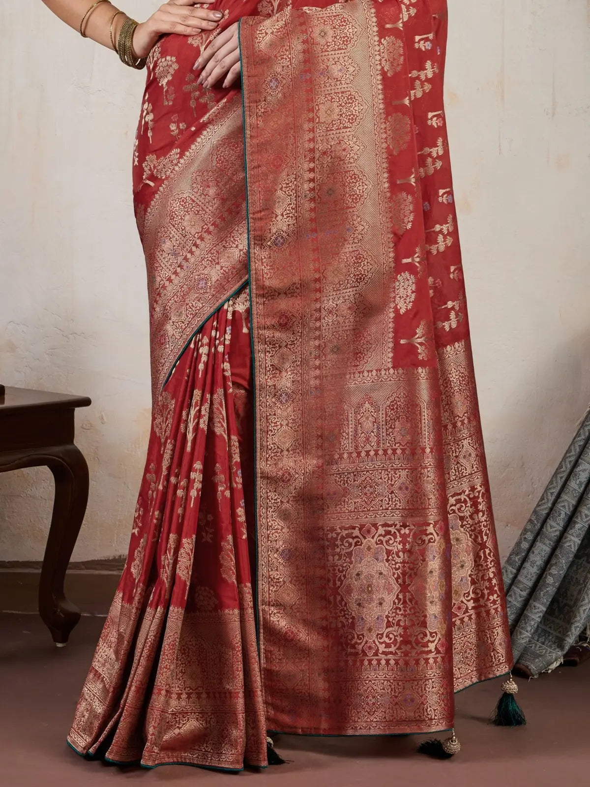 Tarani maroon silk saree pallu view highlighting intricate Meenakari and zari design