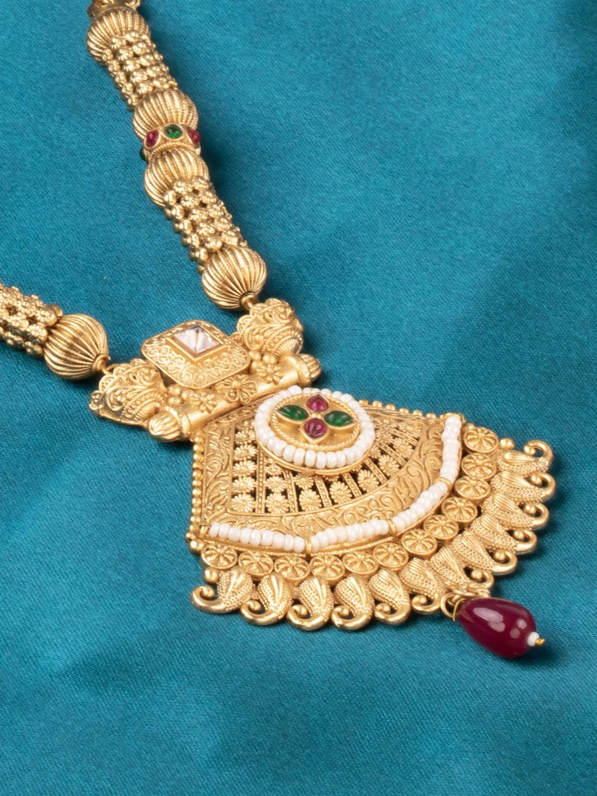 Tarani closeup view of gold plated mangalsutra pendant with stone detailing