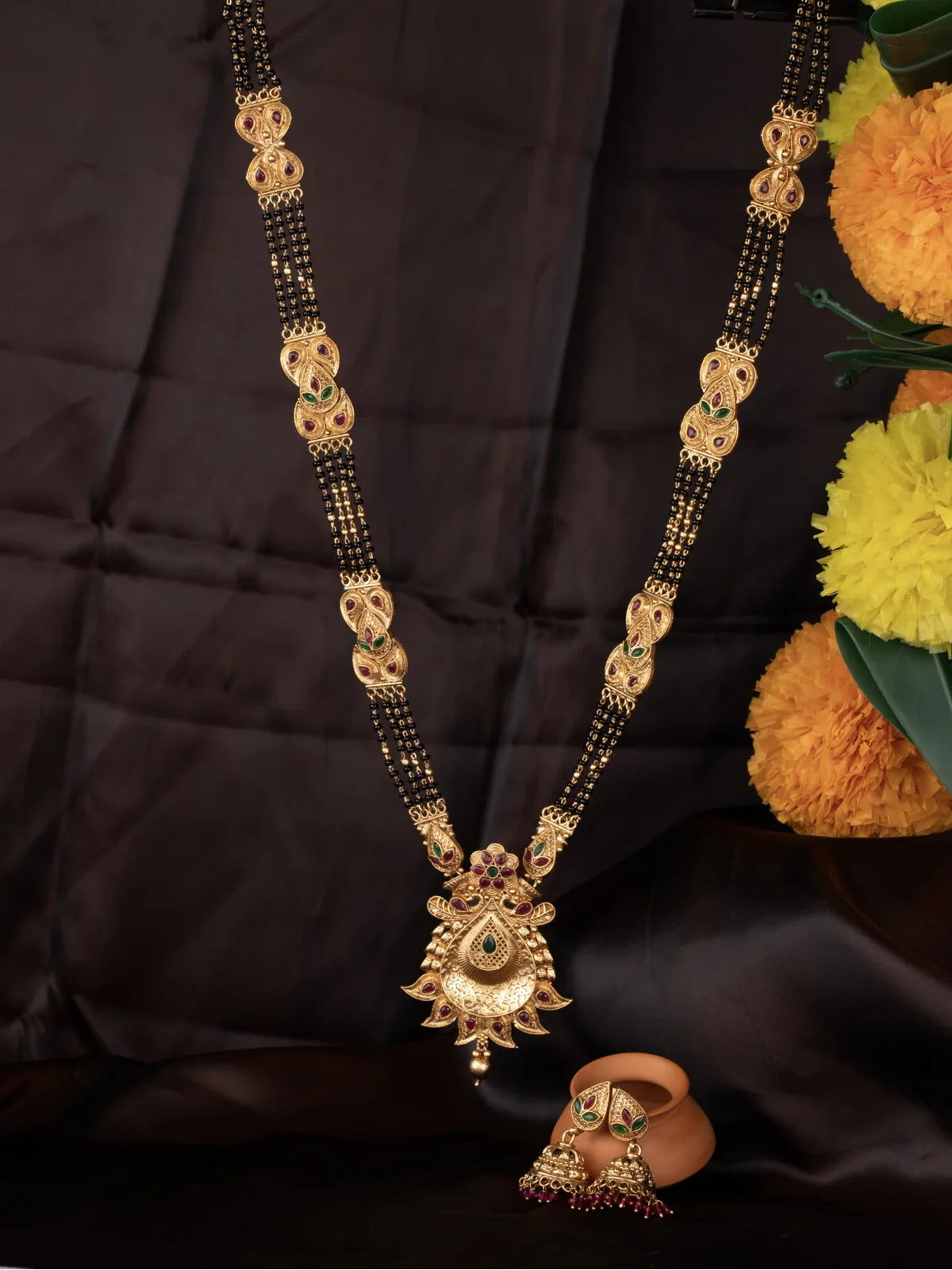 Tarani gold plated traditional mangalsutra with black beads and matching earrings for wedding wear