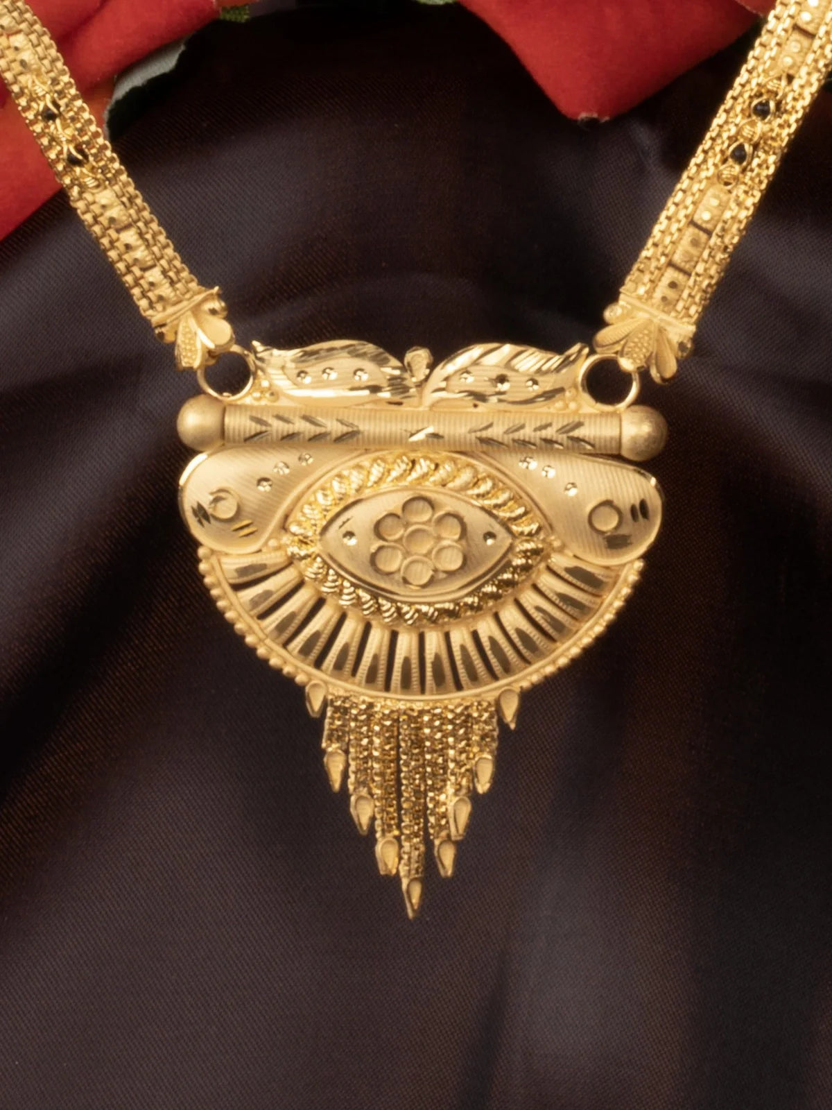 Tarani closeup view of gold plated mangalsutra with traditional pendant and fine detailing