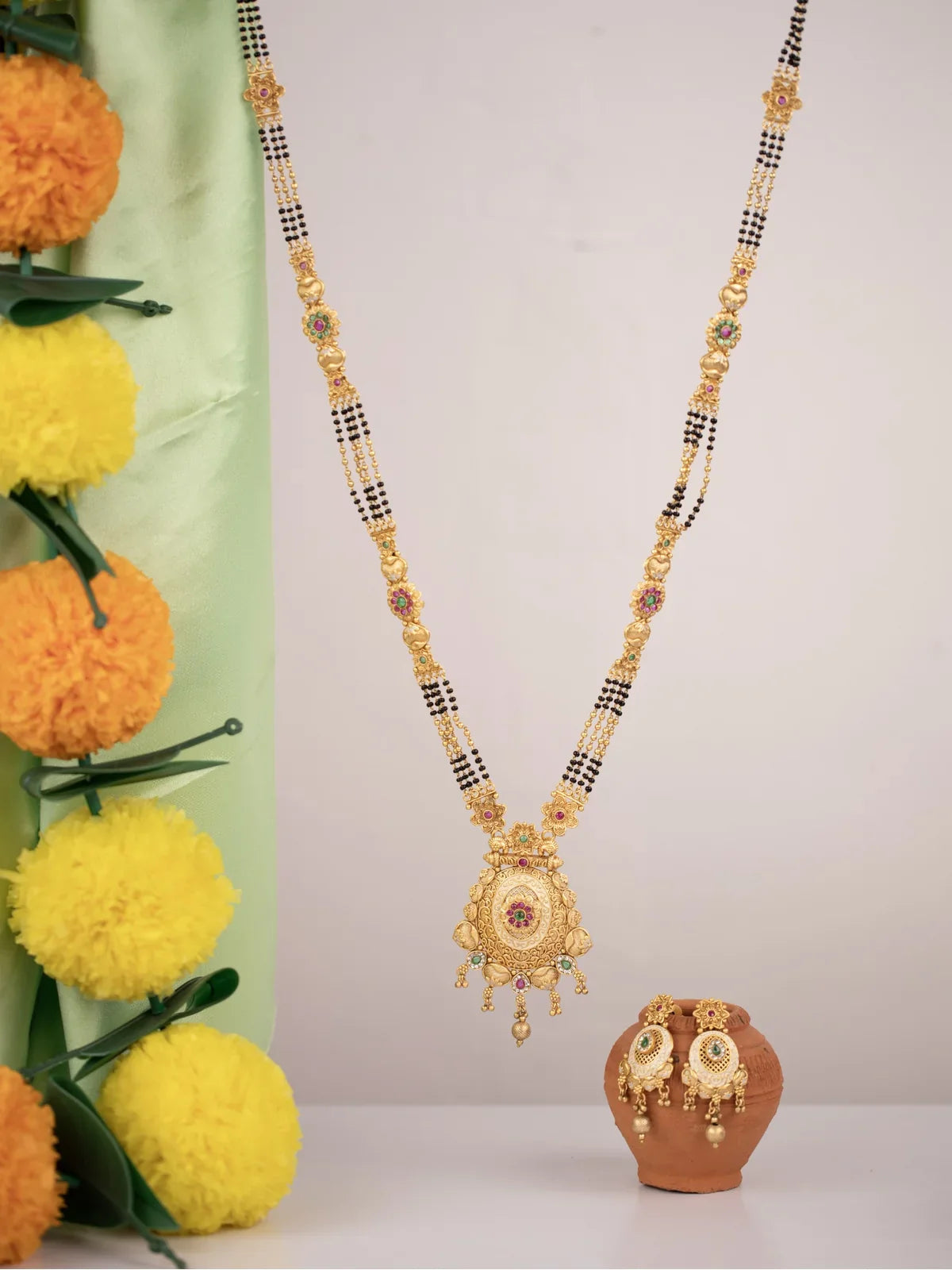 Tarani gold plated stone studded mangalsutra with earrings for festive and wedding wear