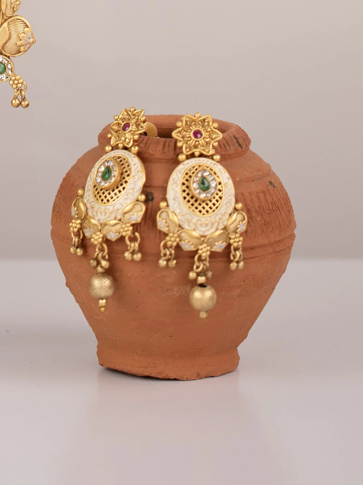 Tarani earrings set with gold plated stone studded design styled for festive occasions