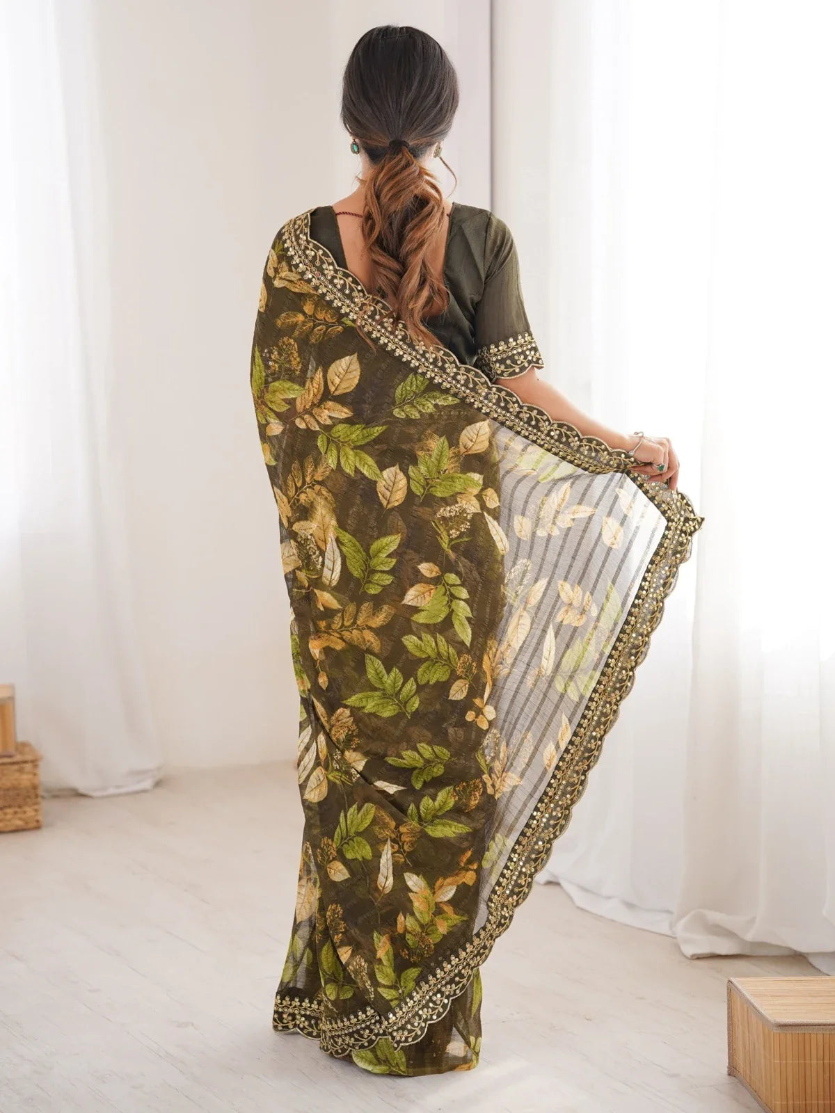 Tarani saree full back view with golden embroidered border and flowing drape