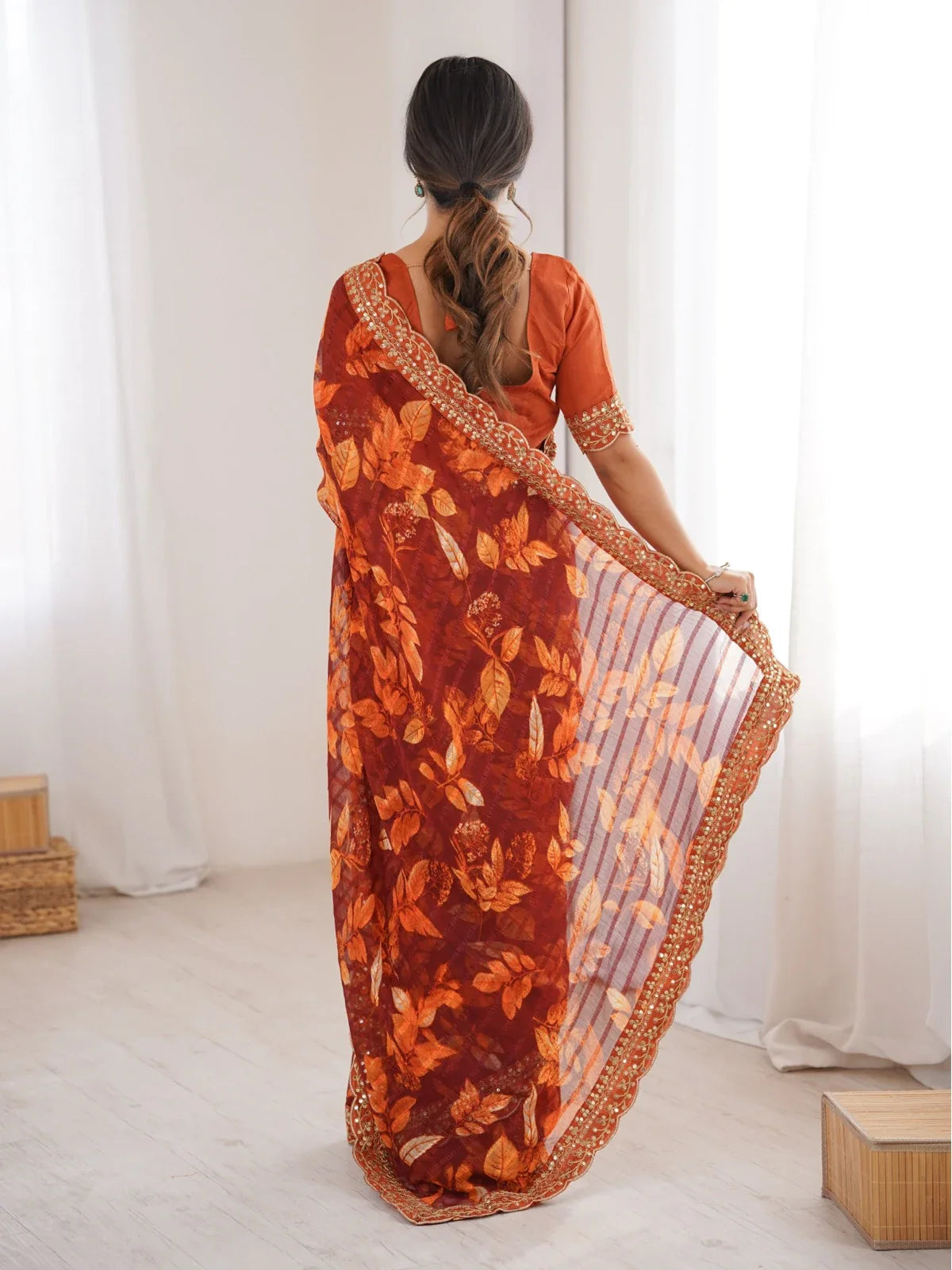 Tarani maroon saree full back view showing floral drape and embroidered blouse