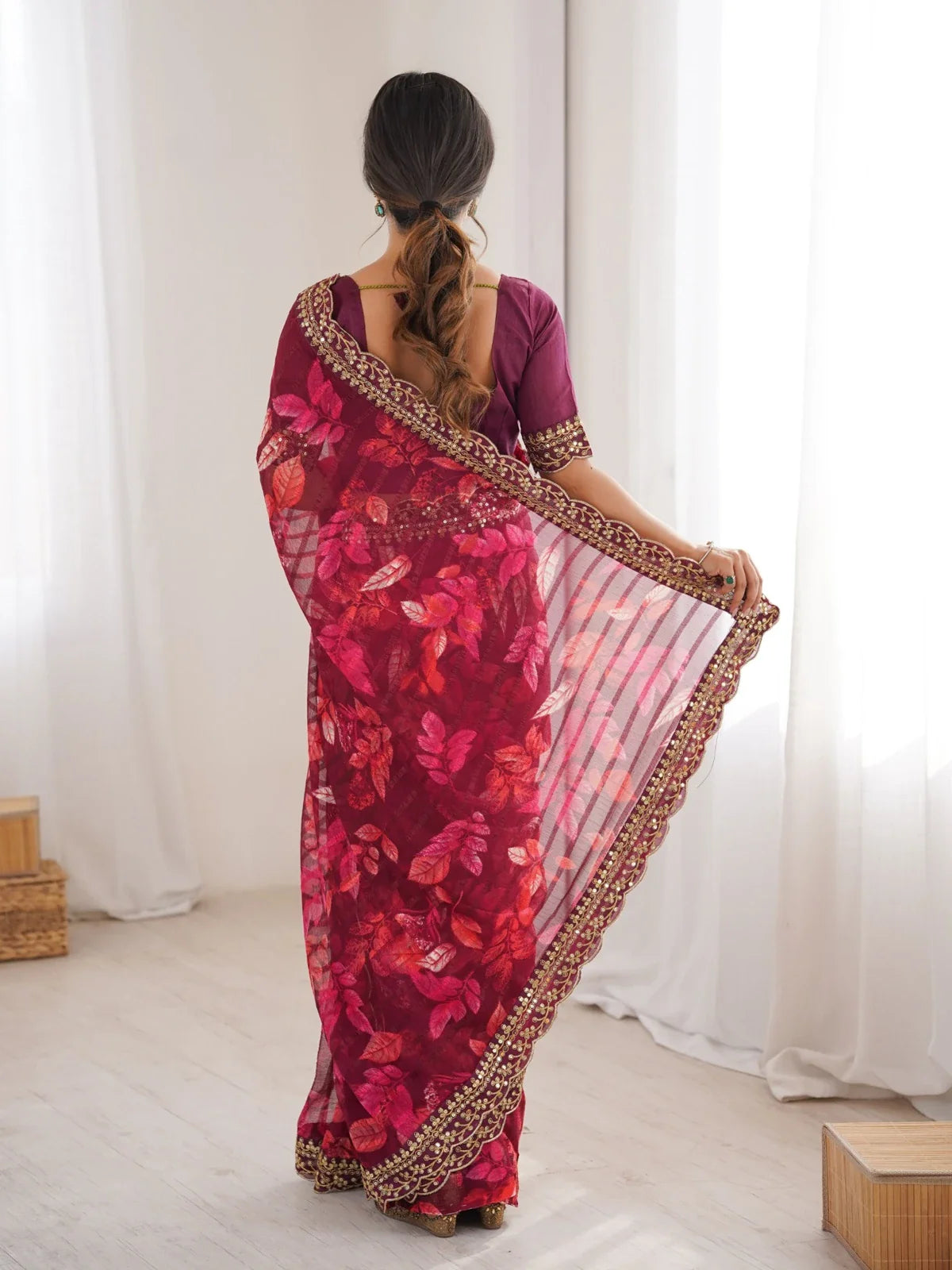 Back view of Tarani maroon saree with see-through pallu and embroidered border