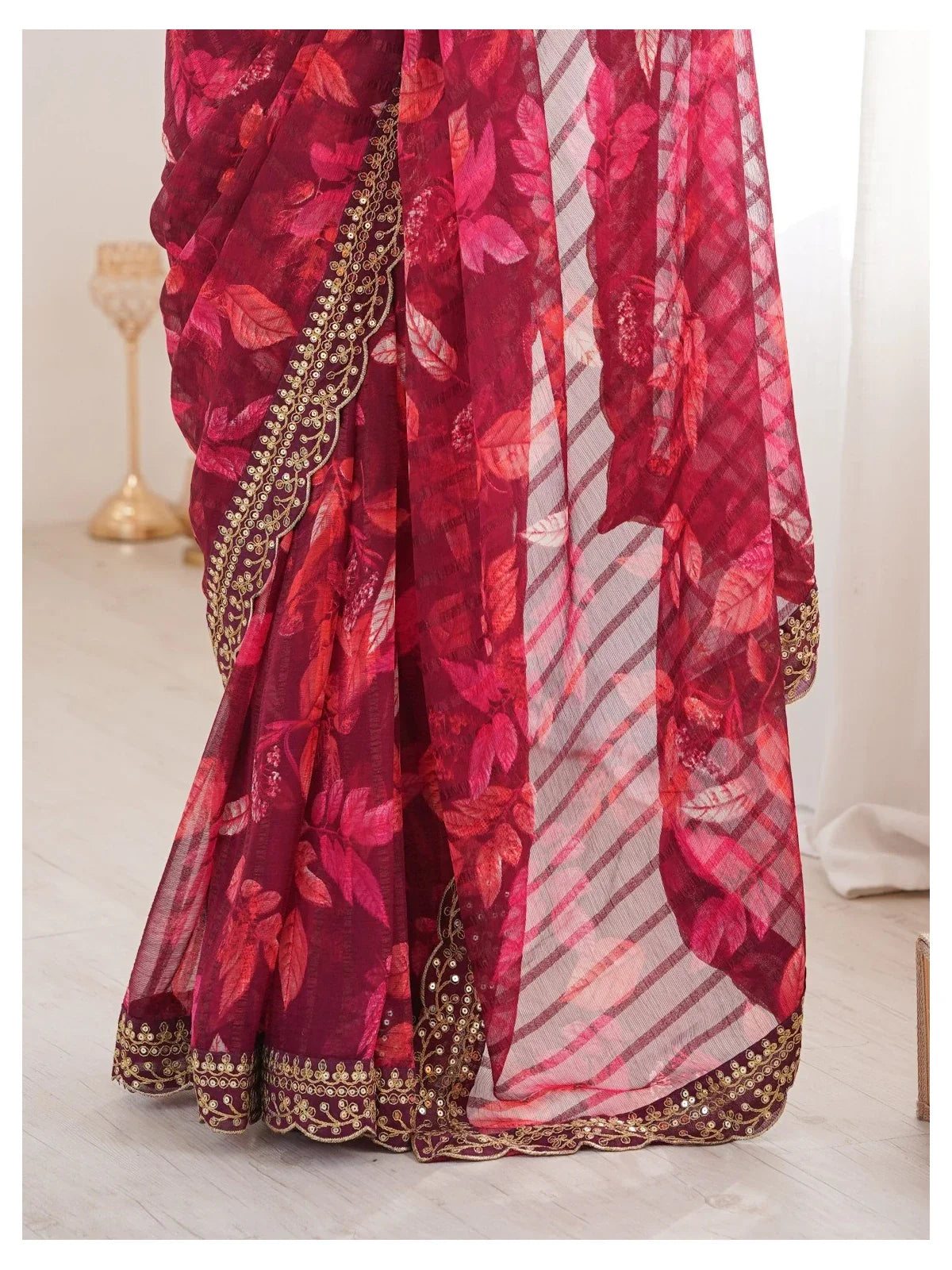 Tarani saree fabric closeup with floral motifs and golden embroidery