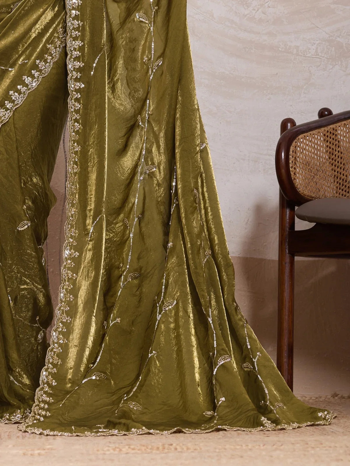 Tarani green satin saree pallu close-up with elegant cutdana beads and zari work border