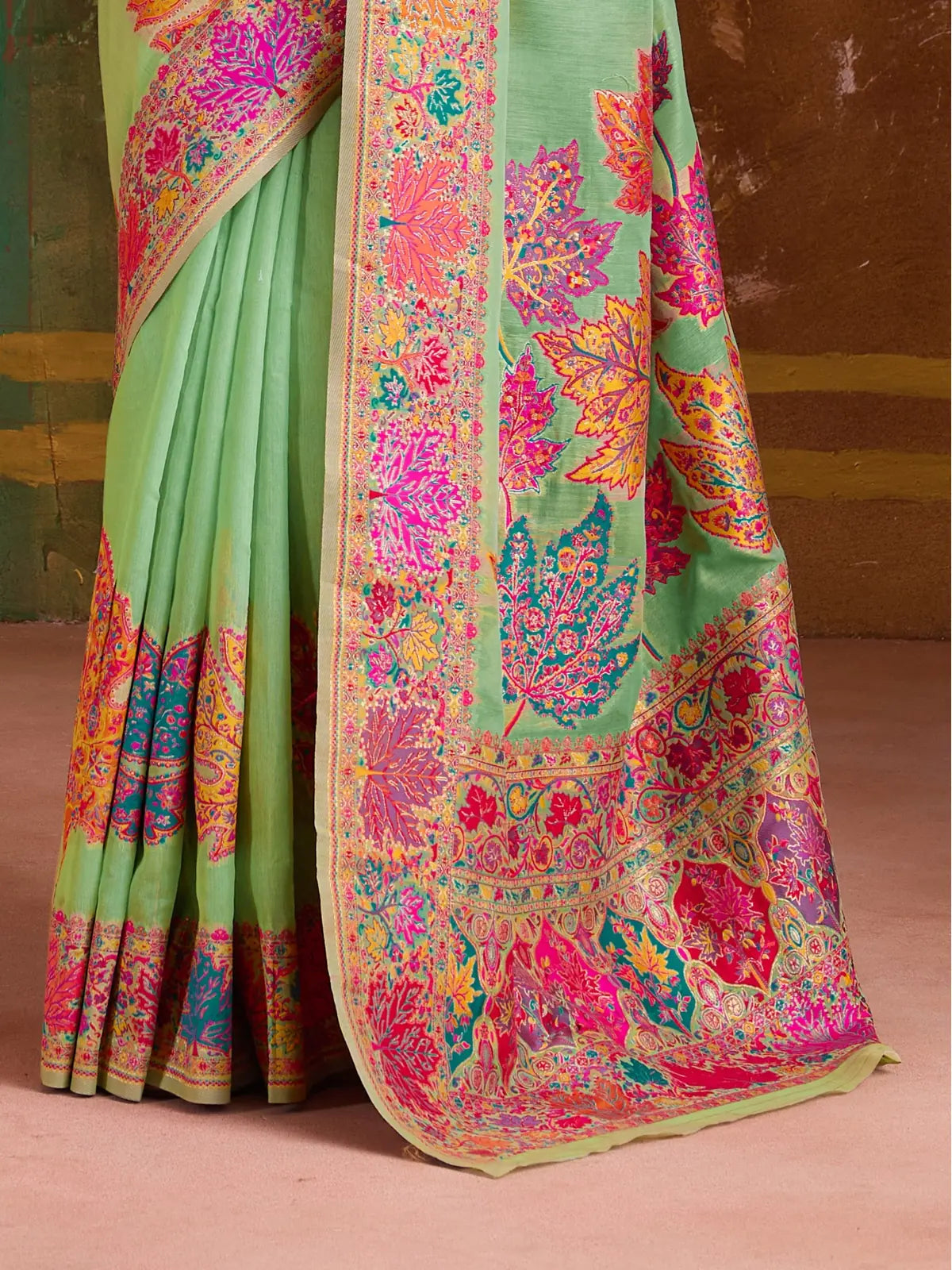 Tarani close-up of saree border and pallu design in green and pink with yellow