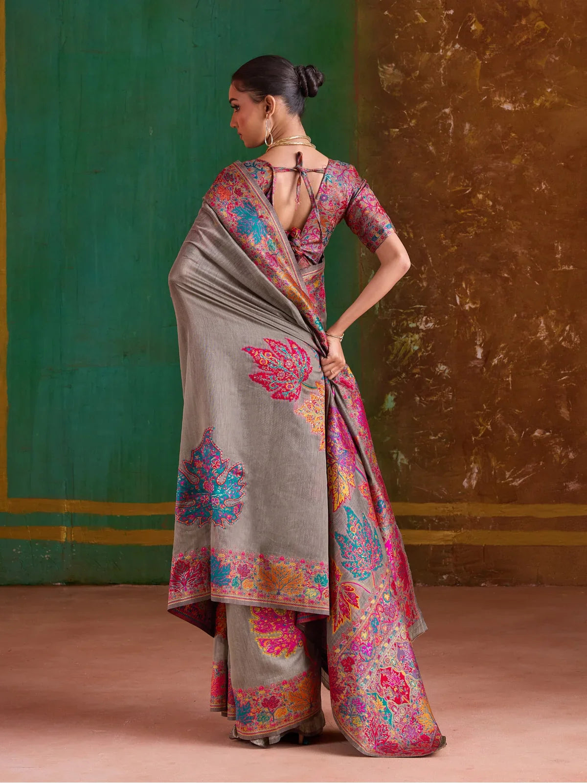 Tarani grey pashmina saree with colorful threadwork seen from back view