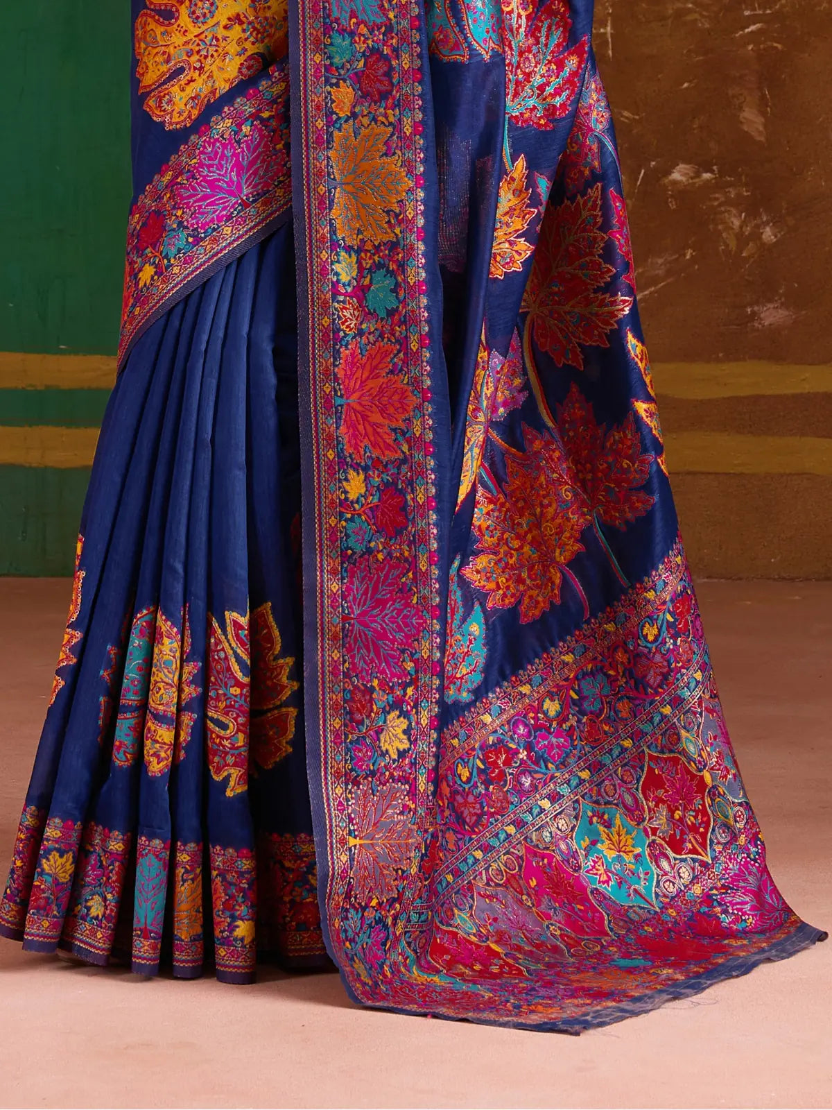 Tarani premium modal cotton pashmina saree fabric with intricate weaving and maple leaf motifs in pink, yellow and blue, closeup view