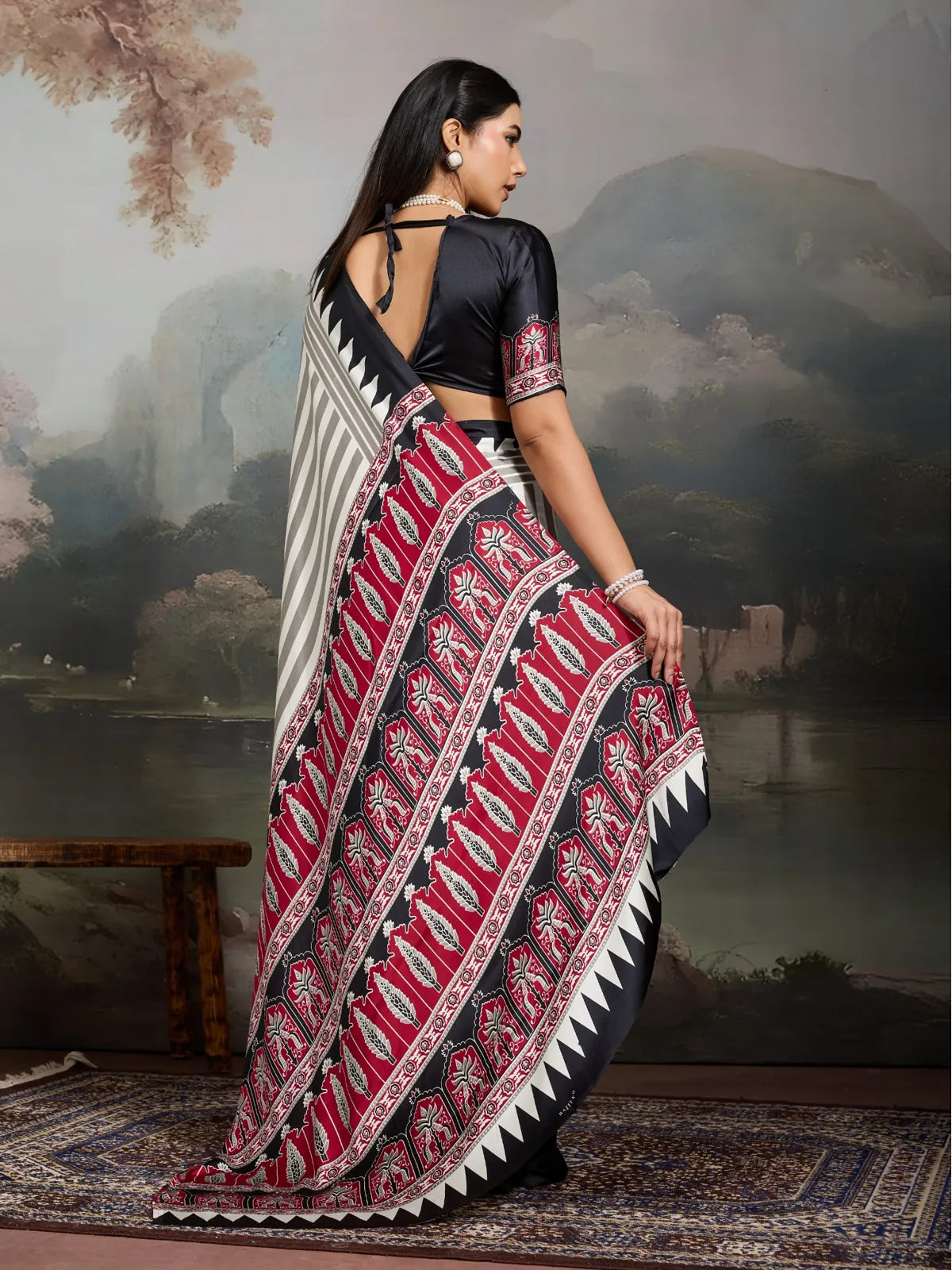 Back pose showing Tarani saree drape and open-back blouse with red ajrakh sleeve detail