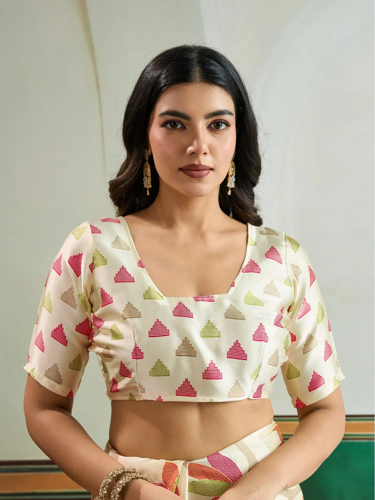 Tarani beige saree close-up blouse view with pink green and brown Ajrakh-inspired motifs