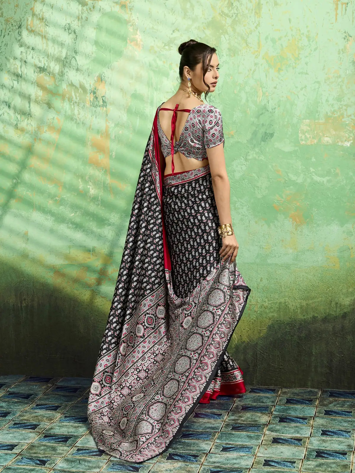 Tarani black Ajrakh print saree back view with designer blouse pattern and flowing pallu