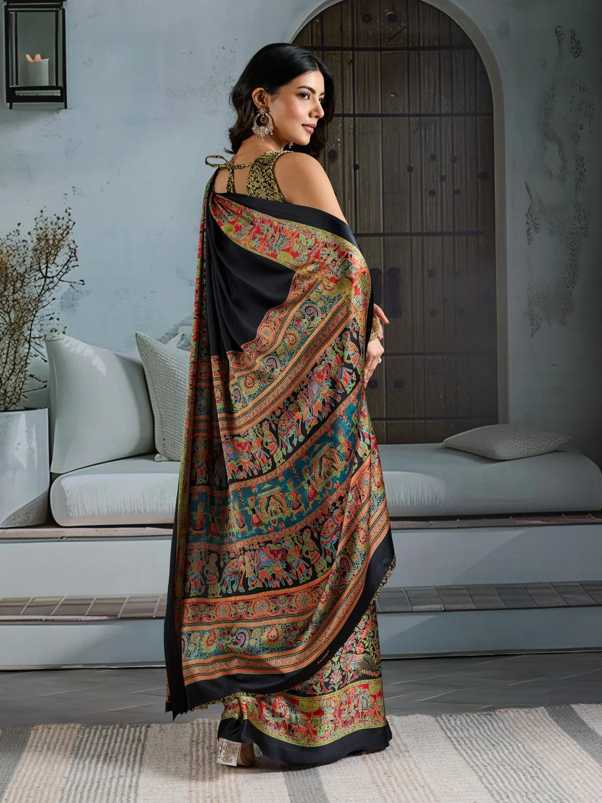 Tarani black modal satin saree with artistic ajrakh border in graceful back view