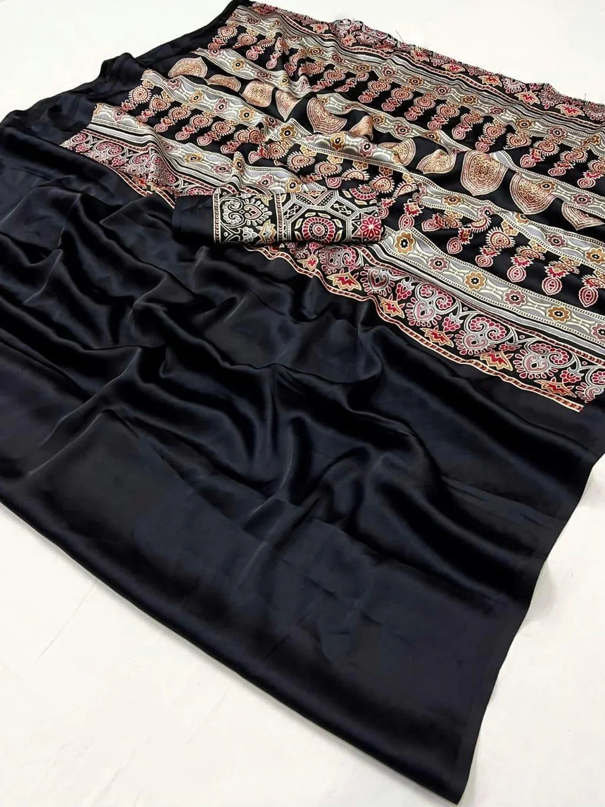 Tarani closeup of black modal satin saree fabric with printed detailing and soft shine