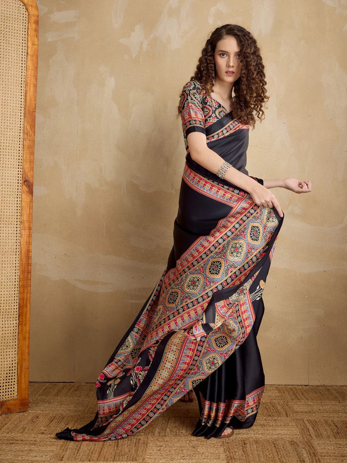 Tarani black modal satin saree with full Ajrakh print and vibrant border worn in full view