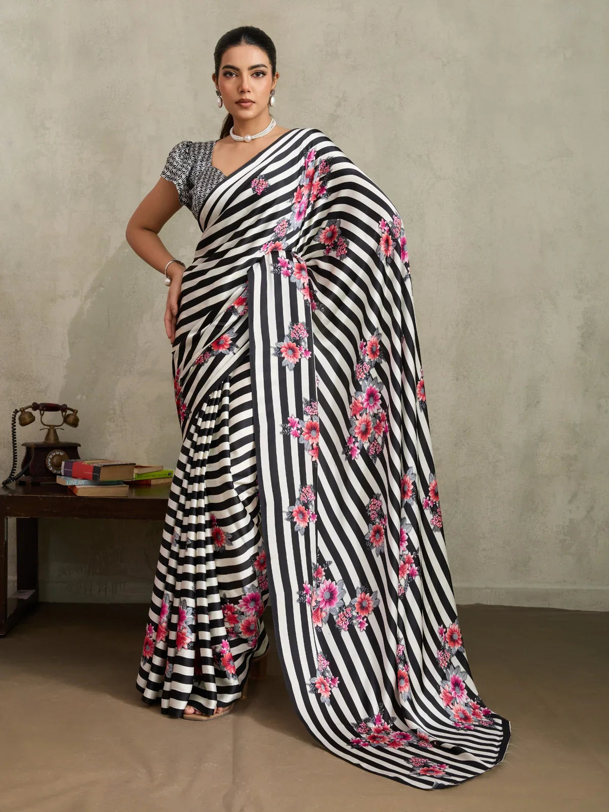 Tarani black and white striped modal satin saree with pink floral print displayed in full drape on model